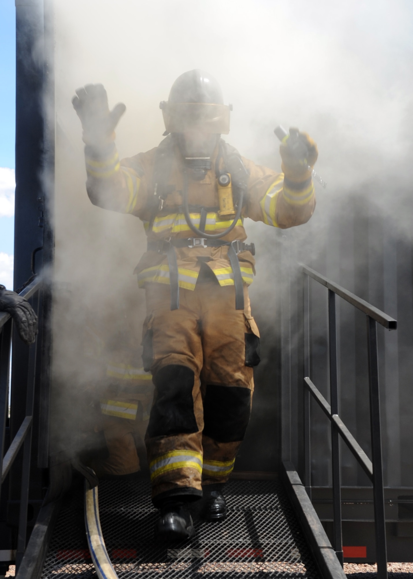 ALTUS Air Force Base, Okla. – Chuck French, Oklahoma State University fire service training instructor, walks out of the fire flashover simulator during a fire flashover exercise at the base training pit, Aug. 28, 2012. The exercise was held to show the firefighters how to recognize and escape a room before a fire flashover occurs. (U.S. Air Force photo by Airman 1st Class Franklin R. Ramos / 97th Air Mobility Wing / Released)