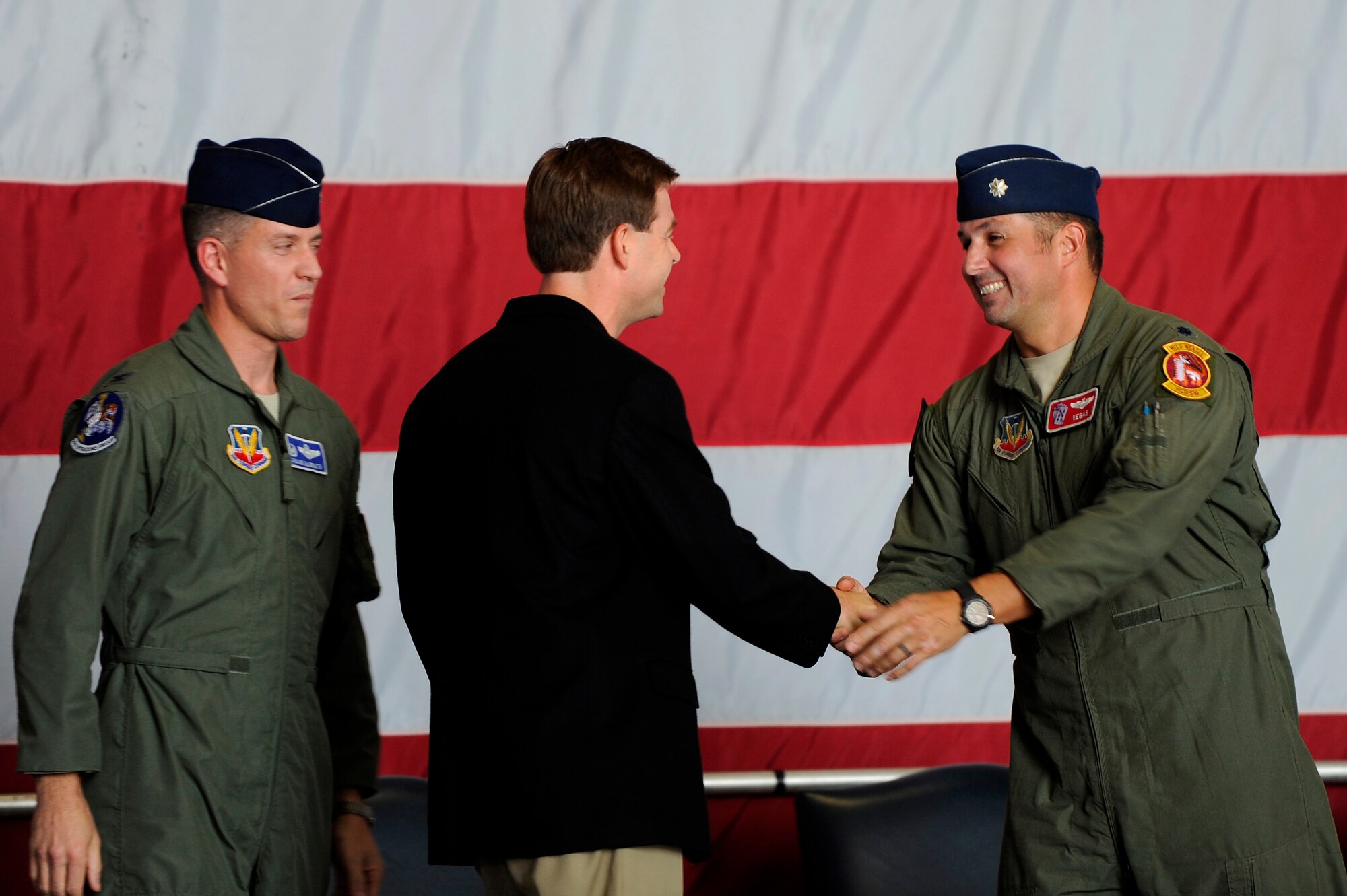 Dr. Steven Lauzon; a Sumter Surgical partner, (center), shakes hands with Lt. Col. John Vargas, 77th Fighter Squadron commander after assuming honorary command during an honorary commander assumption of command ceremony, Aug. 24, 2012, Shaw Air Force Base, S.C. Lauzon assumed the honorary commander position for the 77th FS. Lauzon has been a longtime supporter of Team Shaw and the 77th FS. The honorary commander program is designed to educate those in the community with limited knowledge of the Air Force and the operations that happen on Shaw. (U.S. Air Force photo by Senior Airman Kenny Holston/Released)
