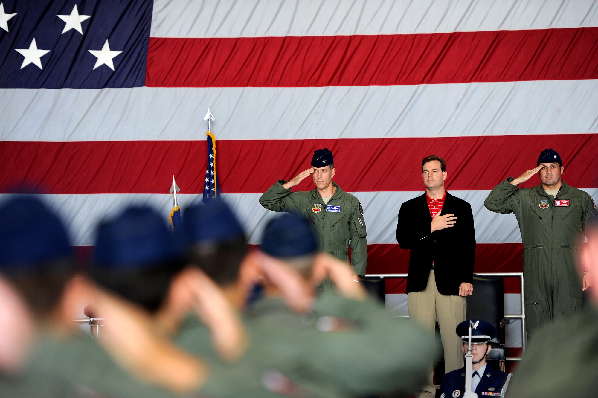 (From left) Col. Shaun McGrath, 20th Operations Group commander, Dr. Steven Lauzon; a Sumter Surgical partner, and Lt. Col. John Vargas, 77th Fighter Squadron commander render the proper respects to the United States flag as the national anthem plays during an honorary commander assumption of command ceremony, Aug. 24, 2012, Shaw Air Force Base, S.C. Lauzon; a Sumter Surgical partner assumed the honorary commander position for the 77th FS. Lauzon has been a longtime supporter of Team Shaw and the 77th FS. The honorary commander program is designed to educate those in the community with limited knowledge of the Air Force and the operations that happen on Shaw. (U.S. Air Force photo by Senior Airman Kenny Holston/Released)