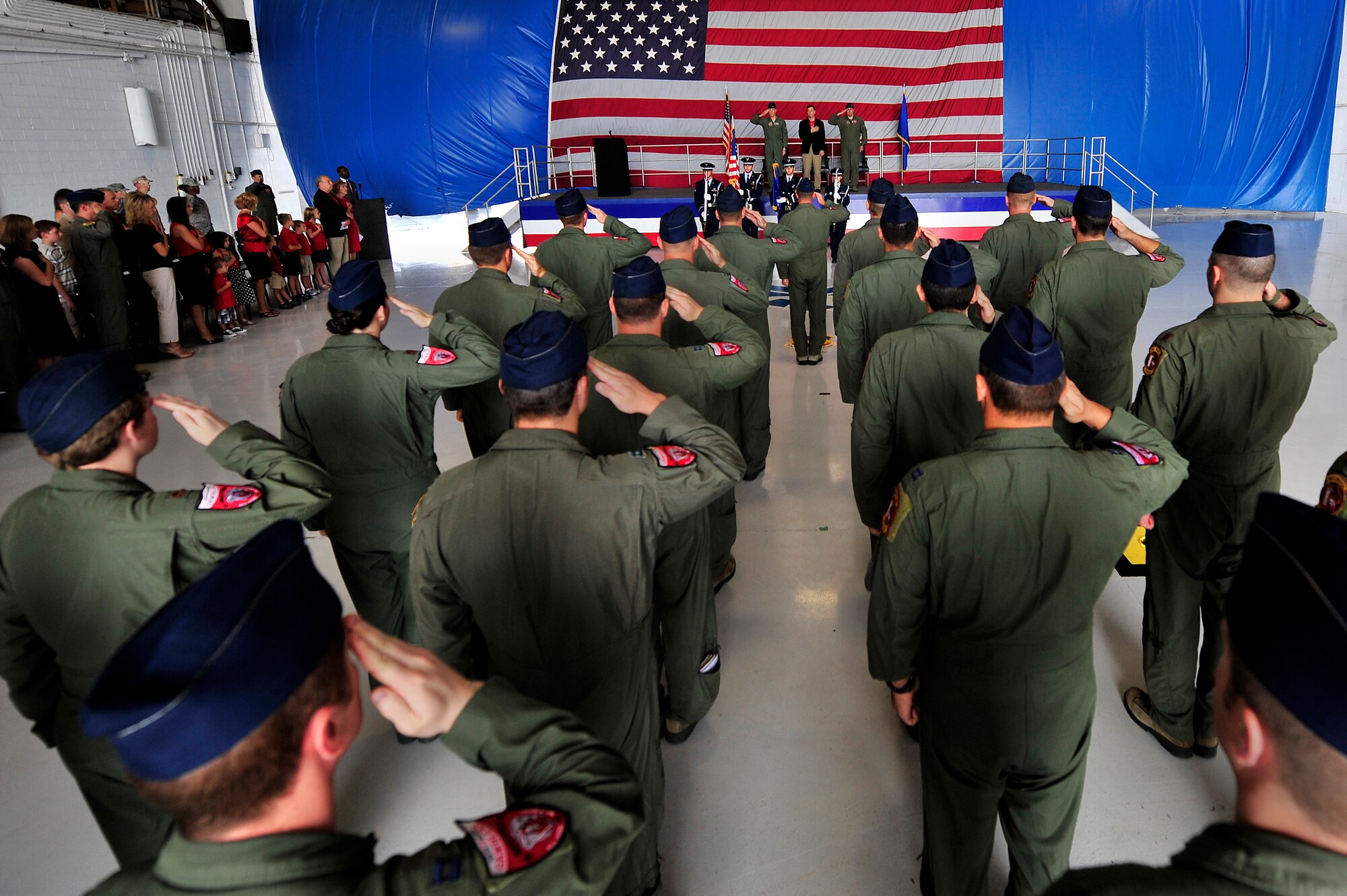 The men and women of the 77th Fighter Squadron render a salute during the playing of the national anthem at an honorary commander assumption of command ceremony, Aug. 24, 2012, Shaw Air Force Base, S.C. Dr. Steven Lauzon; a Sumter Surgical partner assumed the honorary commander position for the 77th FS. Lauzon has been a longtime supporter of Team Shaw and the 77th FS. The honorary commander program is designed to educate those in the community with limited knowledge of the Air Force and the operations that happen on Shaw. (U.S. Air Force photo by Senior Airman Kenny Holston/Released)