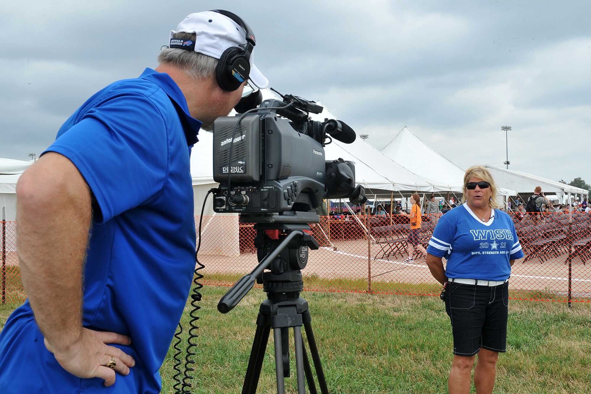 Kevin Schwandt, 55th Wing Public Affairs Audiovisual Production Specialist, interviews Alex Robbin, Chief, Quality Services with the 55th Medical Group, during the 2012 Defenders of Freedom Special Needs Air Show on Offutt Air Force Base, Neb., Aug. 24. Make-A-Wish children and their families spent the day viewing various aircraft on static display and watching flying demonstrations. (U.S. Air Force photo by Charles Haymond)