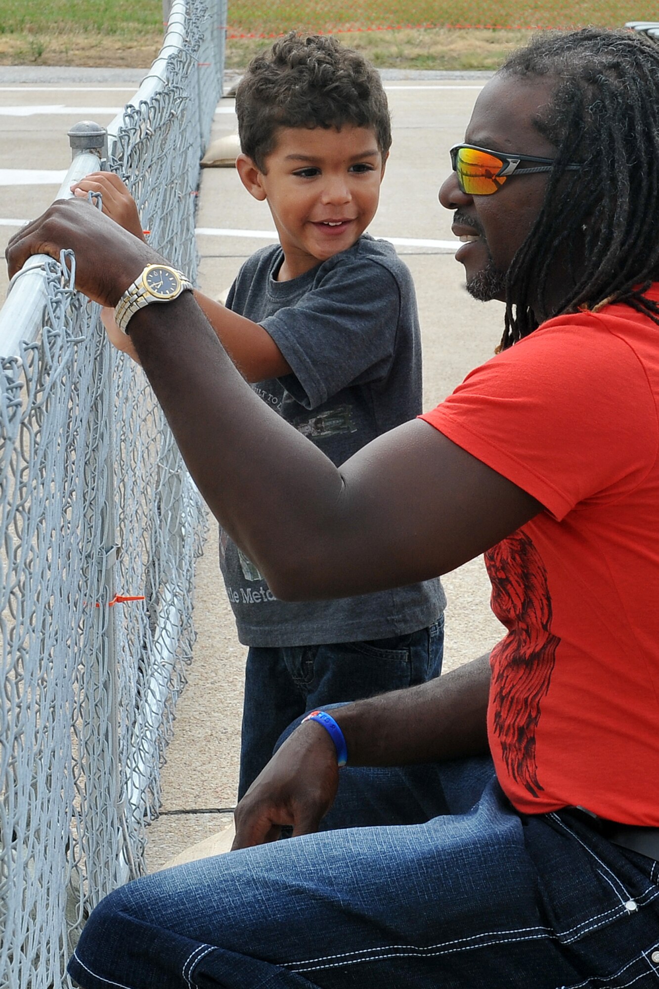 Pierce Bishop asks his father Bryant Bishop about some of the aircraft participating at the 2012 Defenders of Freedom Special Needs Air Show on Offutt Air Force Base, Neb., Aug. 24. Guests to the Defenders of Freedom Open House and Air Show were treated to many static display aircraft, booths and vendors during the two-day show. (U.S. Air Force photo by Charles Haymond/Released)