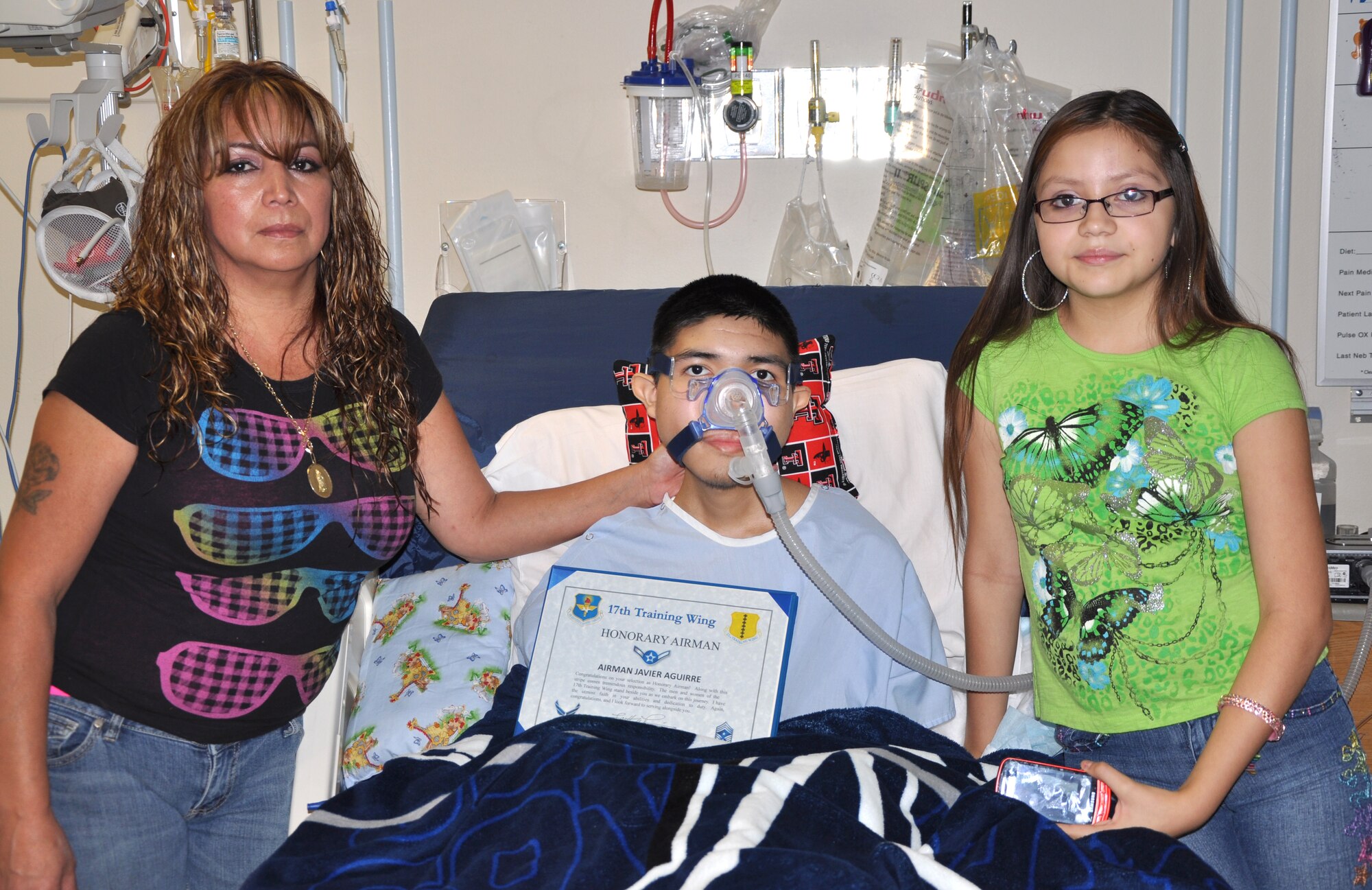 SAN ANGELO, Texas—Javier, 16, and his family pose for a photo at the Shannon Medical Center Aug. 23. Javier, who has a terminal illness, was inducted as an honorary Airman and received a command chief’s coin. (U.S. Air Force photo/Airman 1st Class Jessica Keith) 