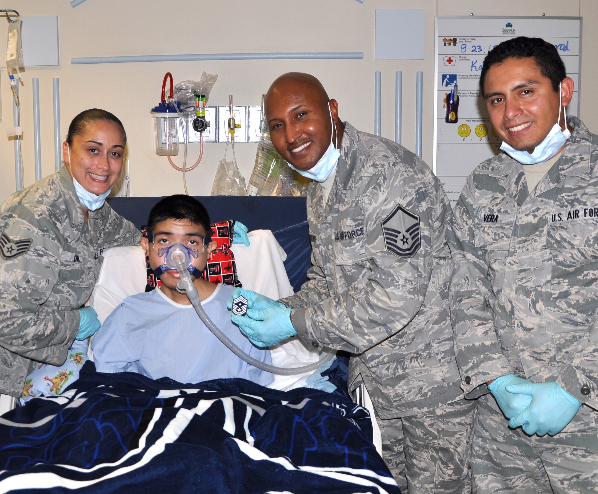 SAN ANGELO, Texas—Javier, 16, is presented a certificate naming him an honorary Airman at the Shannon Medical Center Aug. 23. Javier is suffering from a terminal illness and his greatest wish is to be an Air Force pilot. (U.S. Air Force photo/Airman 1st Class Jessica Keith)