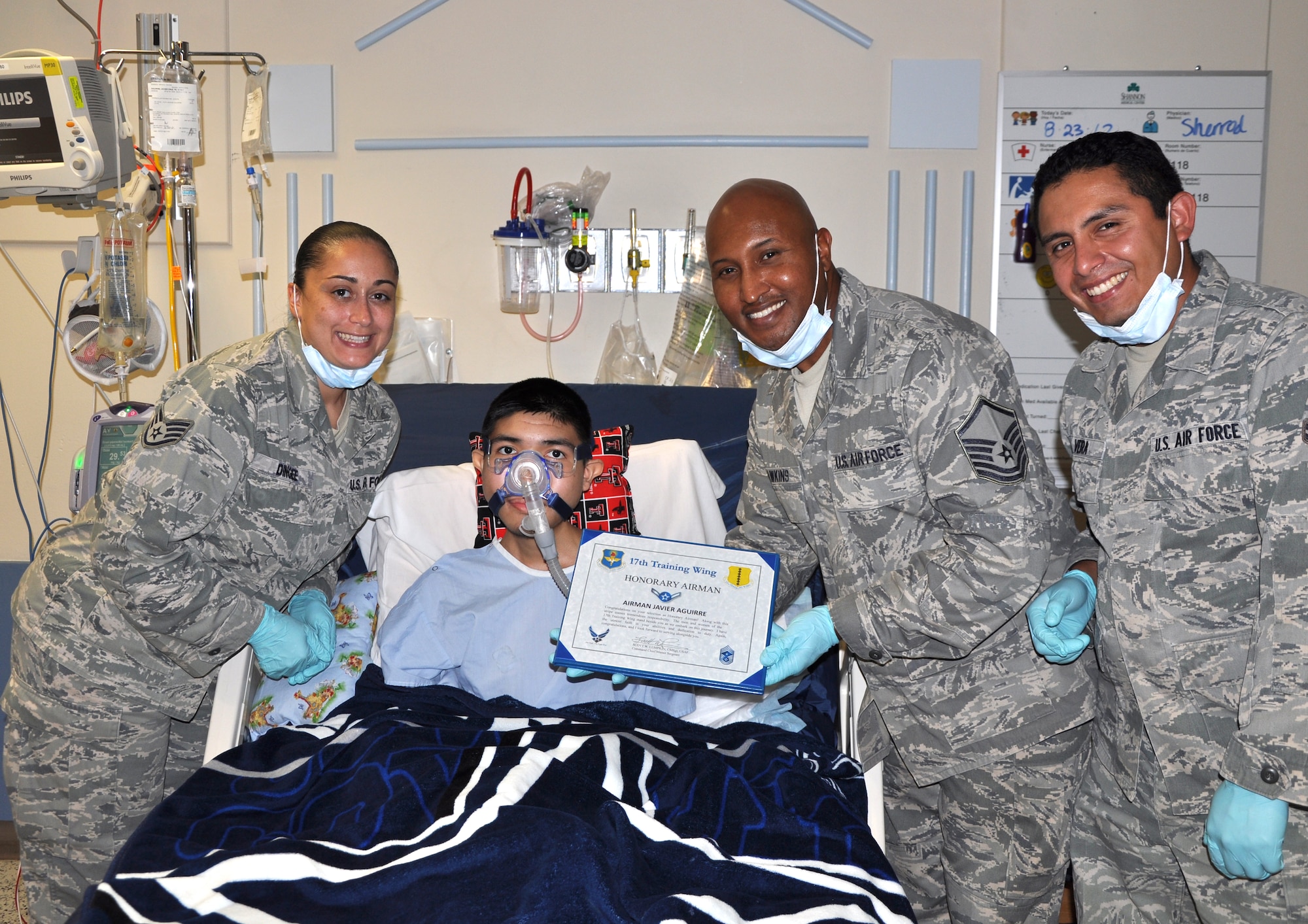 SAN ANGELO, Texas—Javier, 16, is presented a certificate naming him an honorary Airman at the Shannon Medical Center Aug. 23. Javier is suffering from a terminal illness and his greatest wish is to be an Air Force pilot. (U.S. Air Force photo/Airman 1st Class Jessica Keith)