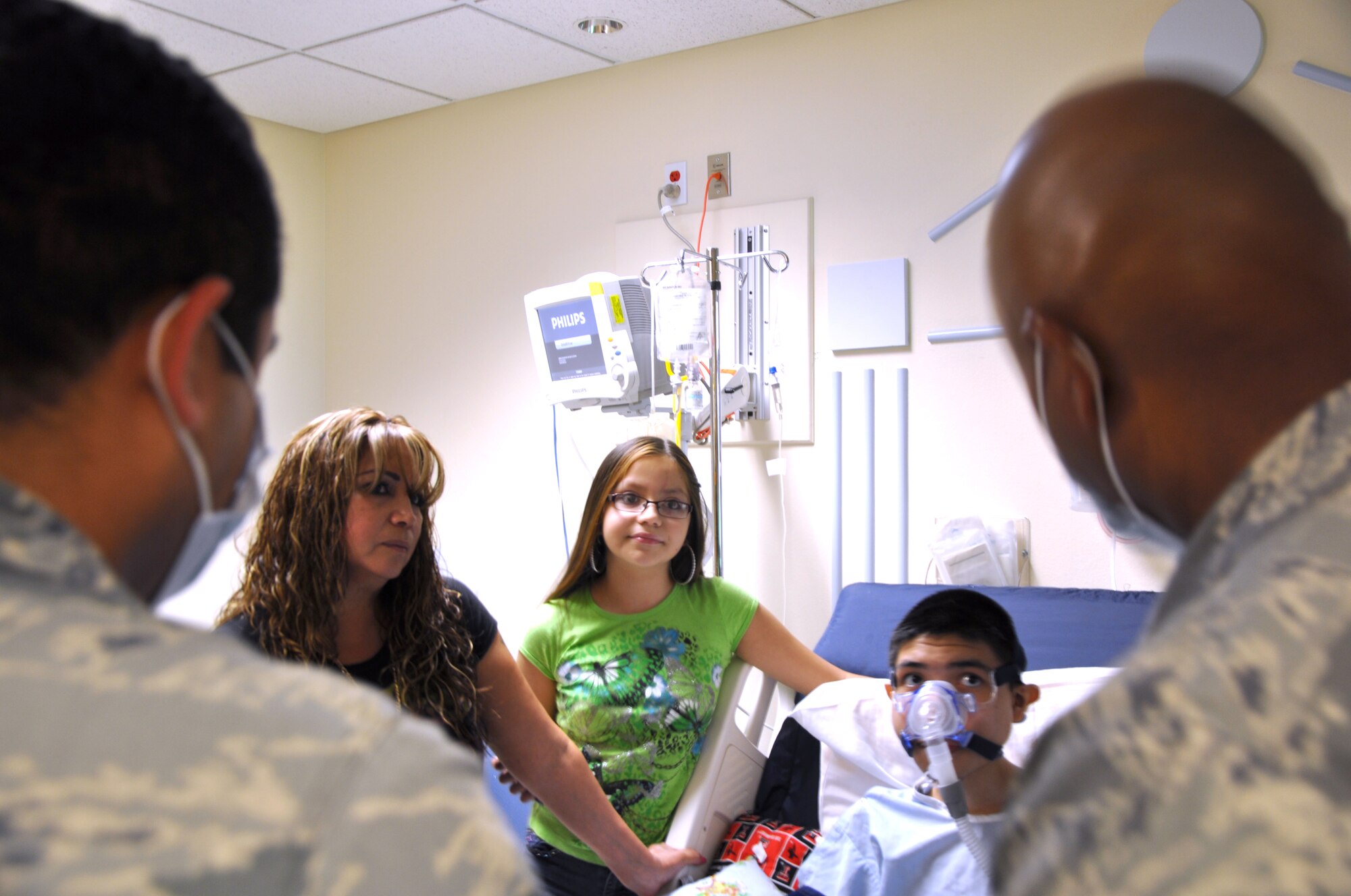 SAN ANGELO, Texas— Service members talk to Javier, 16, and his family about what it means to be a member of the U.S. Air Force before making him an honorary Airman at the Shannon Medical Center Aug. 23. Javier is suffering from a terminal illness and his greatest wish is to be an Air Force pilot. (U.S. Air Force photo/Airman 1st Class Jessica Keith) 