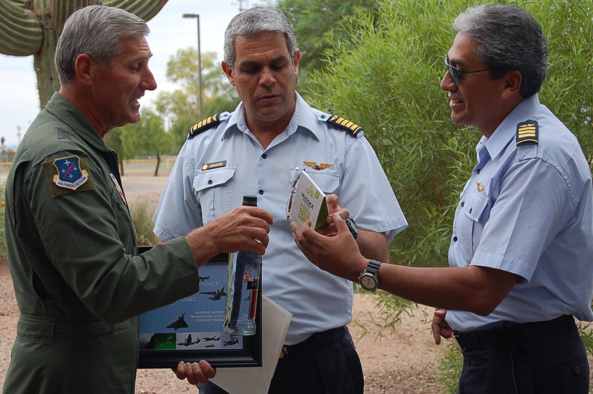 Maj. Gen. Lance Undhjem, 12th Air Force (Air Forces Southern) mobility assistant to the commander, receives a small token of appreciation from two members of the Peruvian air force after participating in PANAMAX 12, Aug. 6-17. (USAF photo by Master Sgt. Kelly Ogden/Released). 