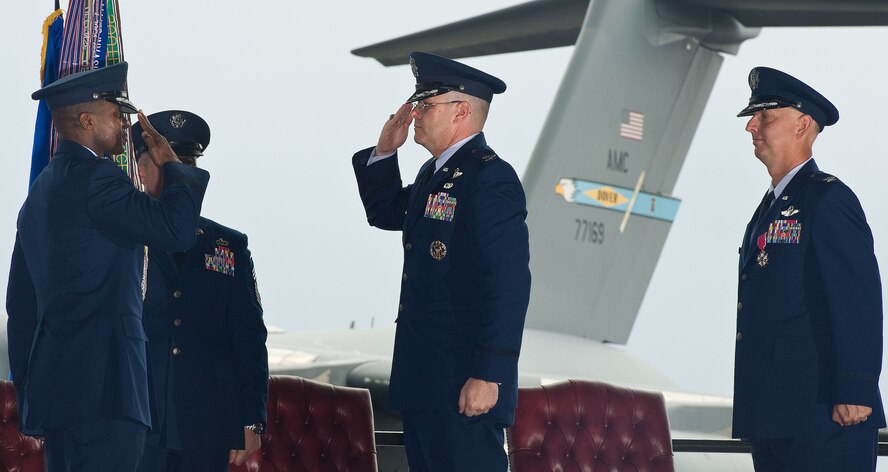 Lt. Gen. Darren McDew, left, 18th Air Force commander, receives a salute from Col. Richard Moore, Jr., the incumbent 436th Airlift Wing commander, during the 436th AW change of command ceremony August 27, 2012, in Hangar 706 at Dover Air Force Base, Del. Col. Mark Camerer relinquished command of the wing to Moore during the ceremony. (U.S. Air Force photo by Roland Balik)