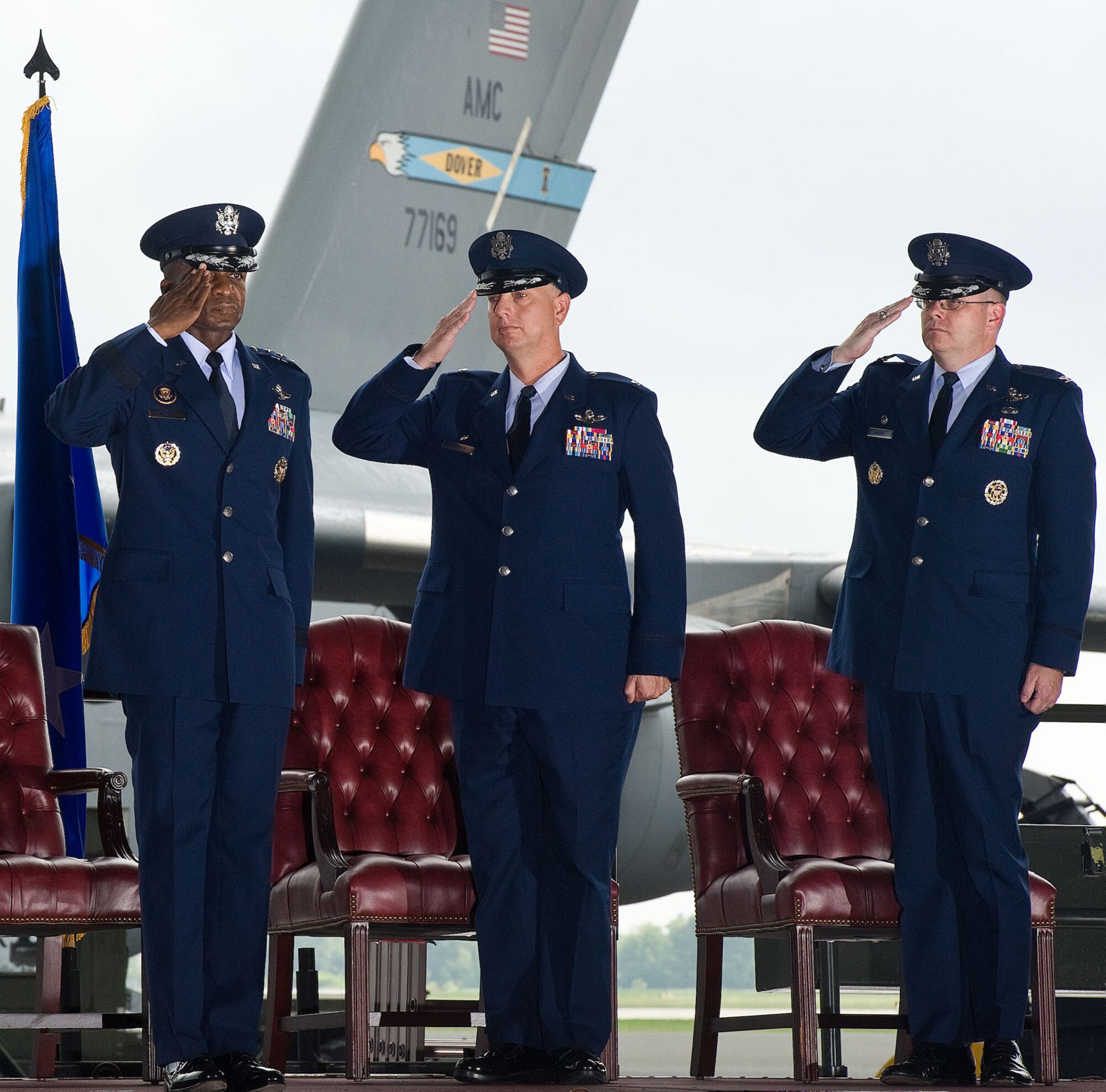 Lt. Gen. Darren McDew, left, 18th Air Force commander, receives salutes from Col. Mark Camerer and Col. Richard Moore, Jr., during the 436th Airlift Wing change of command ceremony August 27, 2012, in Hangar 706 at Dover Air Force Base, Del. Camerer relinquished command of the wing to Moore during the ceremony. (U.S. Air Force photo by Roland Balik)