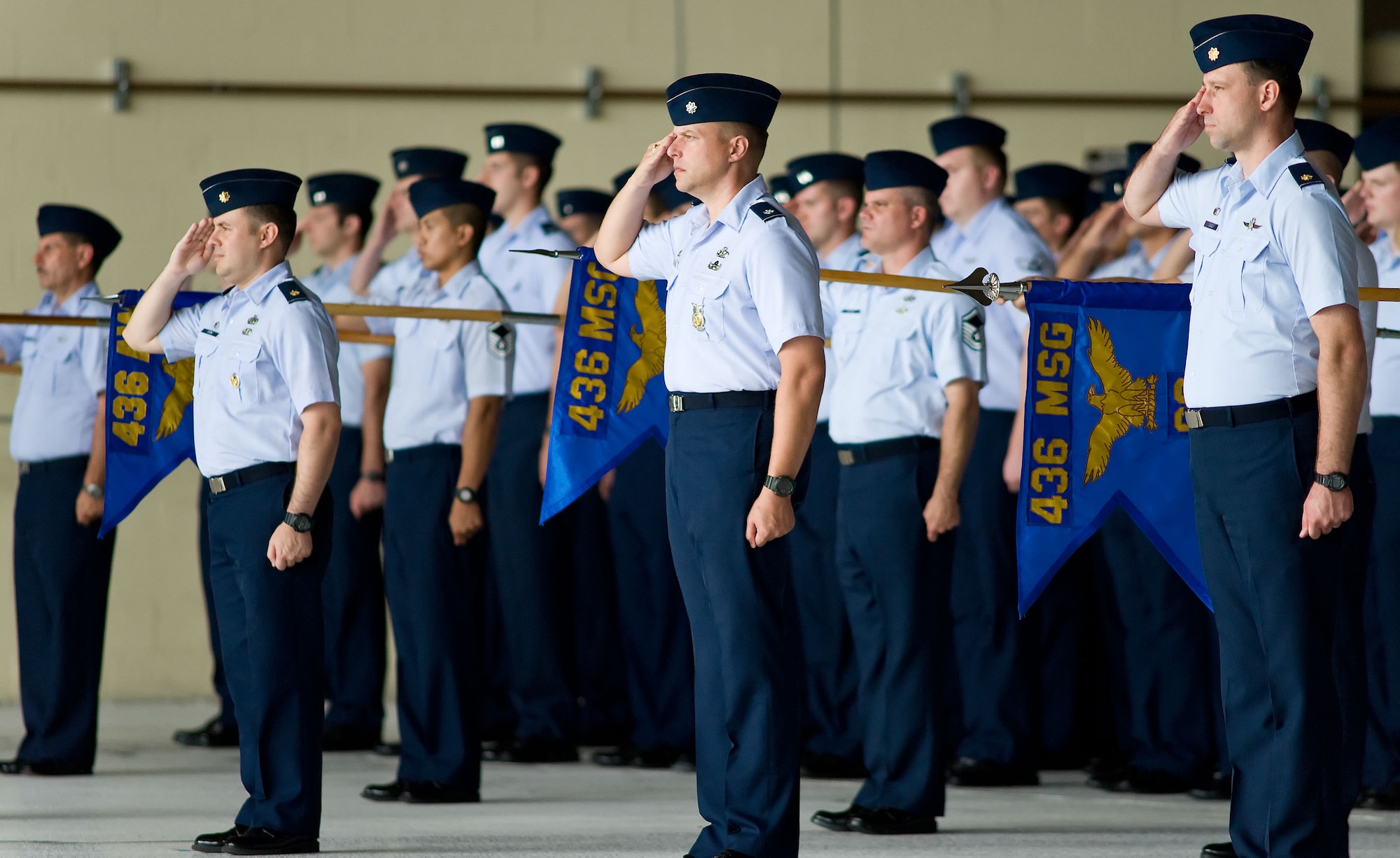 Members of the 436th Airlift Wing render a salute during the Wing's Change of Command ceremony on August 27, 2012, at Dover Air Force Base, Del., in Hangar 706. Col. Mark D. Camerer relinquished command to Col. Richard G. Moore, Jr. Lt. Gen. Darren W. McDew, commander, 18th Air Force, Scott Air Force Base, Ill., officiated the ceremony. (U.S. Air Force photo/Roland Balik)