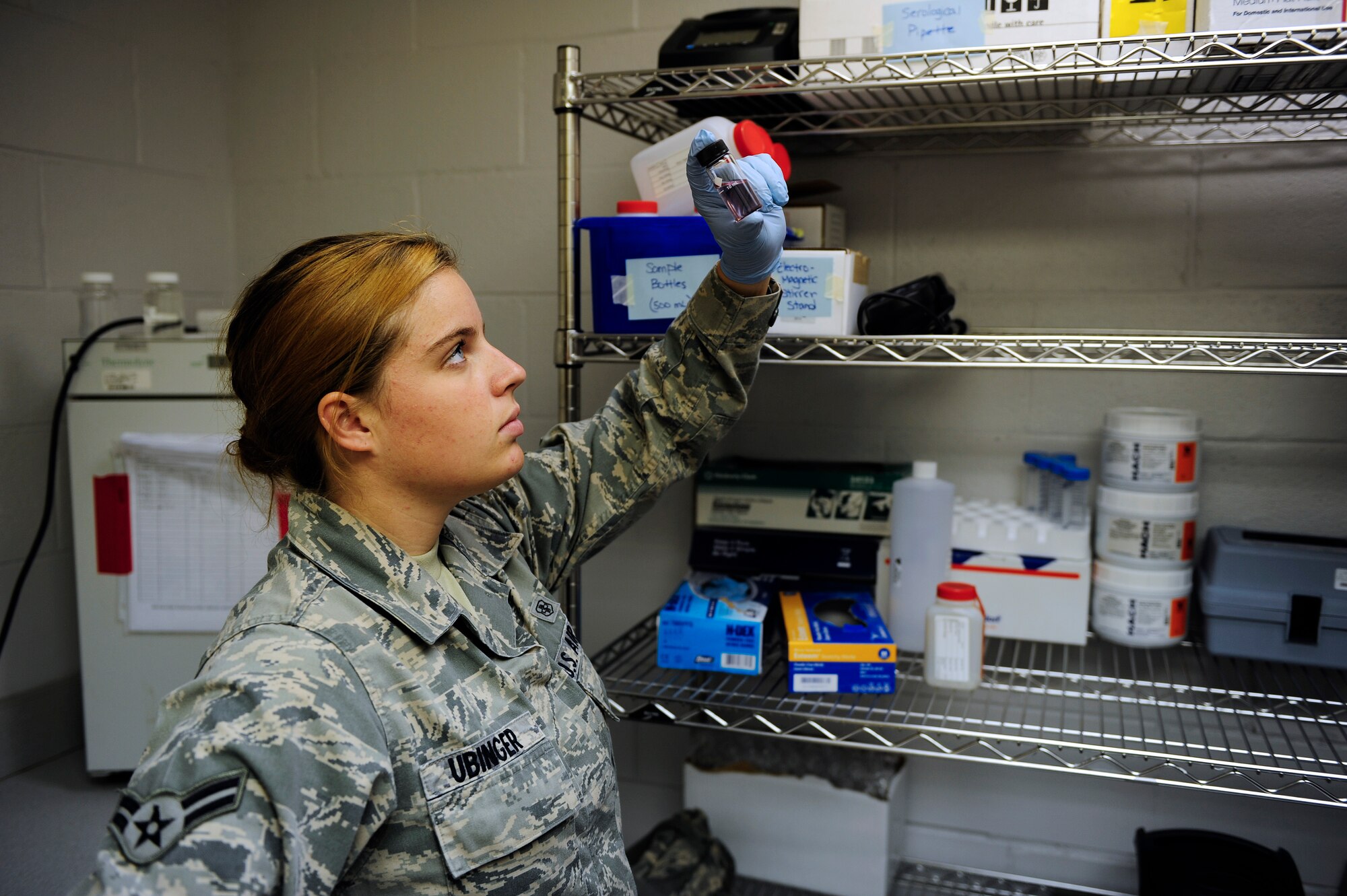Airman 1st Class Amber Ubinger, 20th Aerospace Medical Squadron bioenvironmental technician, examines a water sample, checking for potential contaminates present within the sample at Shaw Air Force Base, S.C., Aug. 17, 2012. By closely, and regularly monitoring the base’s water supply Team Shaw can use the water with confidence knowing it is safe to consume. (U.S. Air Force photo by Airman 1st Class Daniel Blackwell/Released)