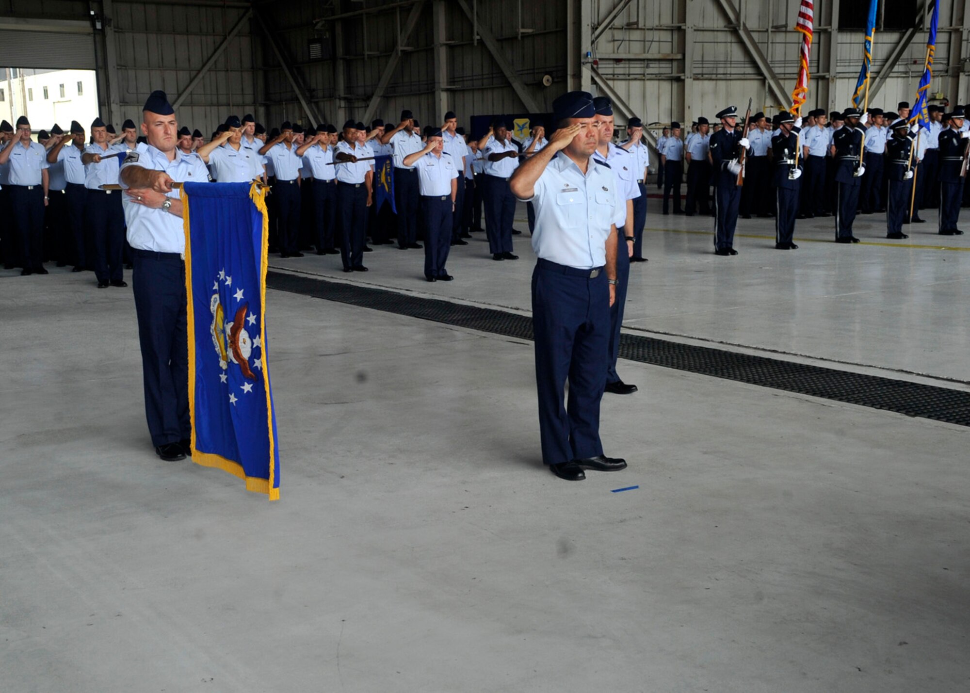 Members of Team Dover render a salute during the change of command ceremony Aug. 27, 2012, on Dover Air Force Base, Del. Col. Richard Moore, Jr., assumed command of the 436th Airlift Wing during the ceremony. (U.S. Air Force photo by Tech. Sgt. Chuck Walker)