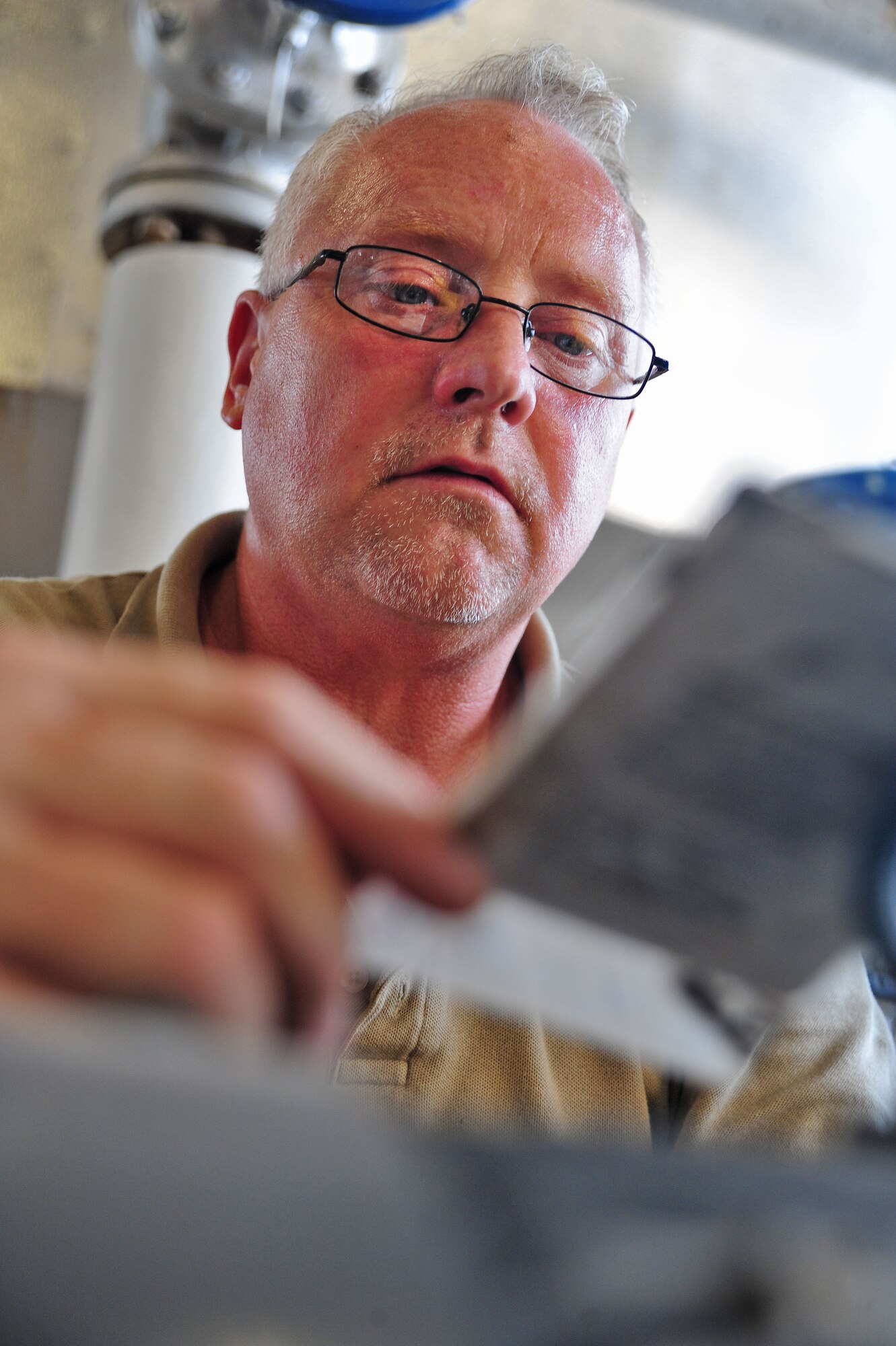 WHITEMAN AIR FORCE BASE, Mo. -- Paul Ross, 509th Civil Engineer Squadron central heat plant project manager, reviews manufacturer data on a piece of equipment so he can order new parts, Aug. 27. The base’s heat plant has a team of professionals who work 24/7 to ensure the multi-million dollar facility stays operational. (U.S. Air Force photo/Senior Airman Nick Wilson) (Released)