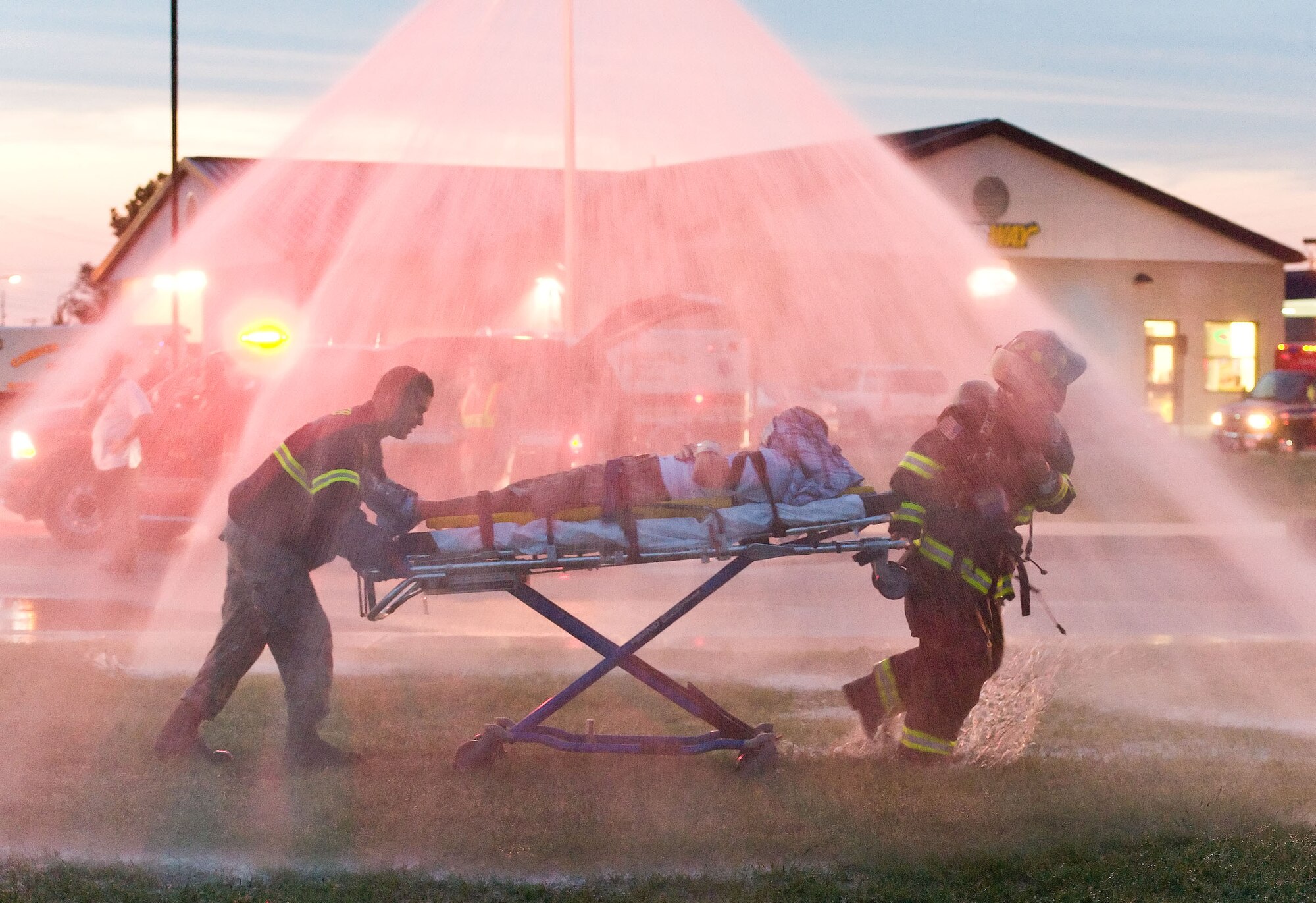First responders from the 436th Civil Engineer Squadron Fire Department take a simulated victim through a temporary decontamination wash Aug. 21, 2012, at Dover Air Force Base, Del. A simulated explosion at the base theater was part of the Aug. 20-22 Major Accident Response Exercise, held to test Team Dover?s ability to respond to threats and emergencies. Dover AFB partnered with members of the local community during the MARE to strengthen cooperation and communication between agencies. (U.S. Air Force photo by Roland Balik)
