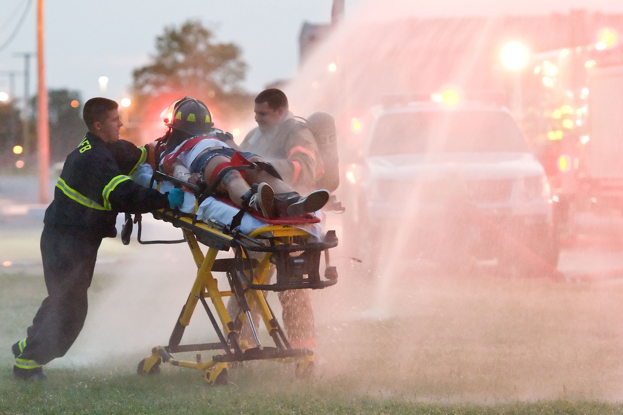 First responders from the 436th Civil Engineer Squadron Fire Department take a simulated victim through a temporary decontamination wash Aug. 21, 2012, at Dover Air Force Base, Del. A simulated explosion at the base theater was part of the Aug. 20-22 Major Accident Response Exercise, held to test Team Dover?s ability to respond to threats and emergencies. Dover AFB partnered with members of the local community during the MARE to strengthen cooperation and communication between agencies. (U.S. Air Force photo by Roland Balik)