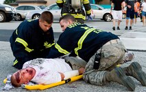 First responders from the 436th Medical Group prepare to transport a simulated victim Aug. 21, 2012, at Dover Air Force Base, Del. A simulated explosion at the base theater was part of the Aug. 20-22 Major Accident Response Exercise, held to test Team Dover?s ability to respond to threats and emergencies. Dover AFB partnered with members of the local community during the MARE to strengthen cooperation and communication between agencies. (U.S. Air Force photo by Roland Balik)