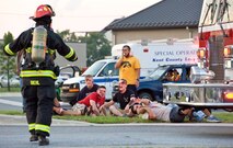 Staff Sgt. Chad Diehl, a firefighter with the 436th Civil Engineer Squadron Fire Department, approaches simulated victims Aug. 21, 2012, at Dover Air Force Base, Del. A simulated explosion at the base theater was part of the Aug. 20-22 Major Accident Response Exercise, held to test Team Dover?s ability to respond to threats and emergencies. Dover AFB partnered with members of the local community during the MARE to strengthen cooperation and communication between agencies. (U.S. Air Force photo by Roland Balik)