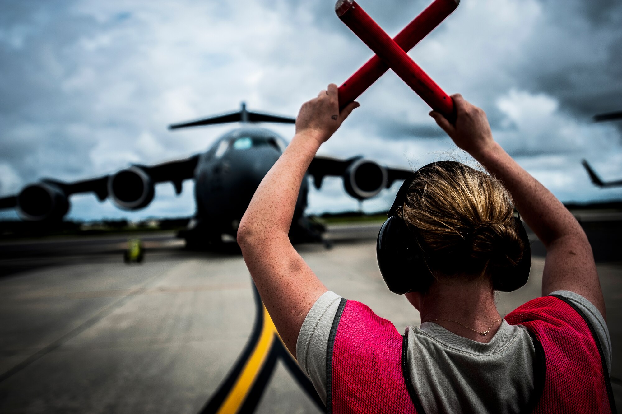 Airman 1st Class Ekaterina Morissette, 437th Aircraft Maintenance Squadron crew chief, wears hearing protection as she marshals in a C-17 Globemaster III Aug. 27, 2012, at Joint Base Charleston - Air Base, S.C. Hearing protection is personal protective equipment that the Hearing Conservation Program requires Airmen to wear to minimize exposure to hazardous noise. (U.S. Air Force photo by Senior Airman Dennis Sloan)