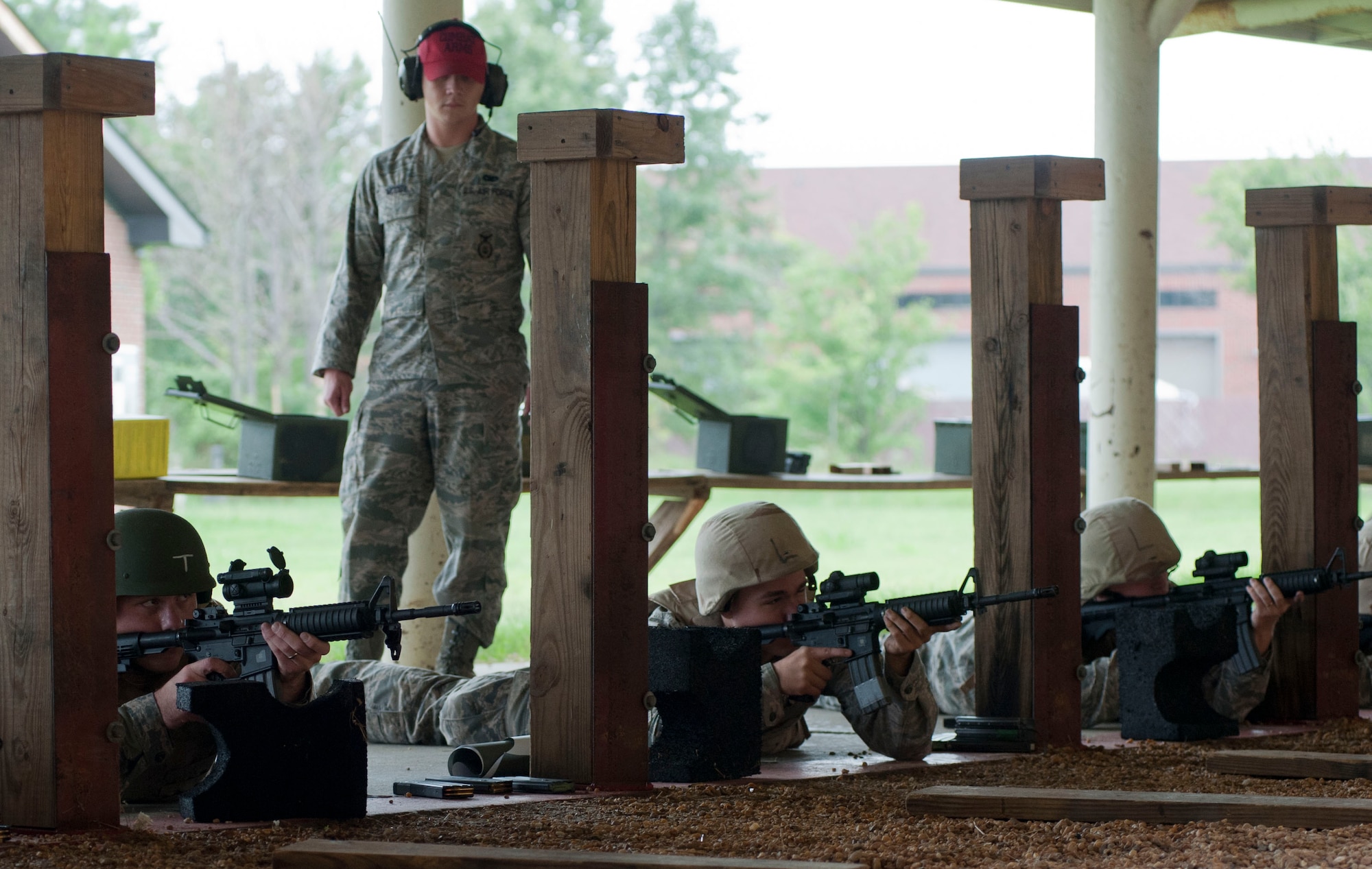 U.S. Air Force Staff Sgt. Patrick McCoy, 633rd Security Forces Squadron Combat Arms instructor, observes students during the M-4 Carbine course at Langley Air Force Base, Va., Aug. 28, 2012. McCoy assisted students throughout the course to ensure proper qualification. (U.S. Air Force photo by Senior Airman Stephanie Rubi/Released) 