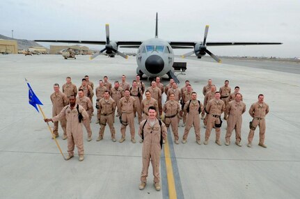 Master Sgt. Erin Manley, 14th Airlift Squadron, 437th Airlift Wing loadmaster instructor, and other members of the 538th Air Expeditionary Advisory Squadron pose for a photo in front of a C-27A Spartan in Kabul, Afghanistan during a 365-day tour. Manley was tasked with training Afghan military members from the newly formed Afghan Air Force to become loadmasters. (Courtesy photo)