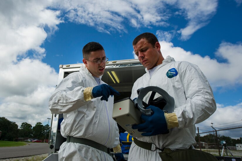 Airman 1st Class William Workman and Senior Airman Nathan Pringle, 628th Civil Engineer Squadron emergency managers, inspect their equipment before participating in training exercise Operation Burnt Spear Aug. 24, 2012, at Joint Base Charleston, S.C. The emergency managers performed radiological response training for a simulated incident involving a dirty bomb. In the scenario, a mock Federal Bureau of Investigation Joint Task Force requested Air Force Emergency Management assistance to verify and contain any radiation present from the device and establish a communication hotline for incoming responders. (U.S. Air Force photo by Airman 1st Class George Goslin)