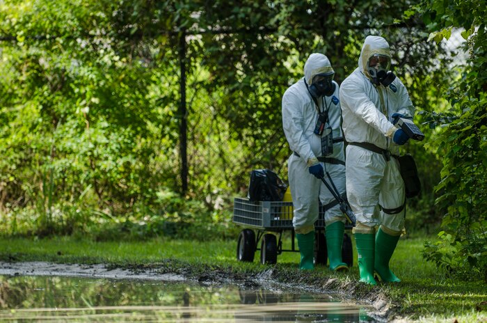 Senior Airman Nathan Pringle and Airman 1st Class William Workman, 628th Civil Engineer Squadron emergency managers, simulate scanning for radiation during training exercise Operation Burnt Spear Aug. 24, 2012, at Joint Base Charleston, S.C. The emergency managers performed radiological response training for a simulated incident involving a dirty bomb. In the scenario, a mock Federal Bureau of Investigation Joint Task Force requested Air Force Emergency Management assistance to verify and contain any radiation present from the device and establish a communication hotline for incoming responders. (U.S. Air Force photo by Airman 1st Class George Goslin)