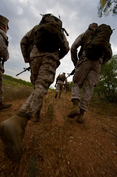 Marines head toward their defensive position during the operations culminating portion of the Corporal’s Course Aug. 24, 2012, at Dyess Air Force Base, Texas. The Corporals Course is a two-week program focused on providing the skills necessary to lead Marines and is designed to provide the war fighting skill, core values and mindset necessary for effective leadership of a team and subordinate Marines. Upon completion, corporals have the skills necessary to clearly articulate one’s thoughts in both oral and written communications; understand the standards of leadership traits, principles and fundamentals; understand the NCO mindset of "doing instead of knowing;" and execute and apply tactical measures at the team level. (U.S. Air Force photo by Airman 1st Class Damon Kasberg/Released)