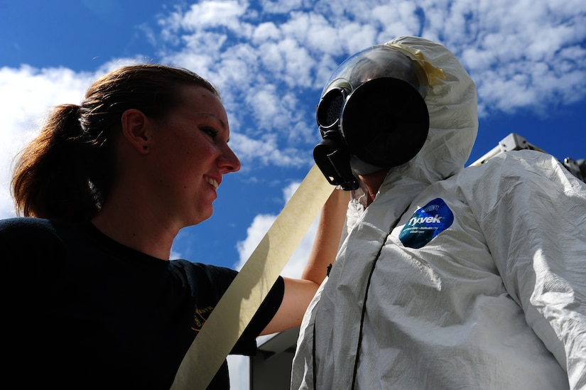 Michelle Bates, 628th Civil Engineer Squadron emergency manager, tapes down the mask of Senior Airman Nathan Pringle, 628th Civil Engineer Squadron emergency manager during training exercise Operation Burnt Spear Aug. 24, 2012, at Joint Base Charleston, S.C. The emergency managers conducted radiological response training for a simulated incident involving a dirty bomb. In the scenario, a mock Federal Bureau of Investigation Joint Task Force requested Air Force Emergency Management assistance to verify and contain any radiation present from the device and establish a communication hotline for incoming responders. (U.S. Air Force photo/ Airman 1st Class Chacarra Walker) 