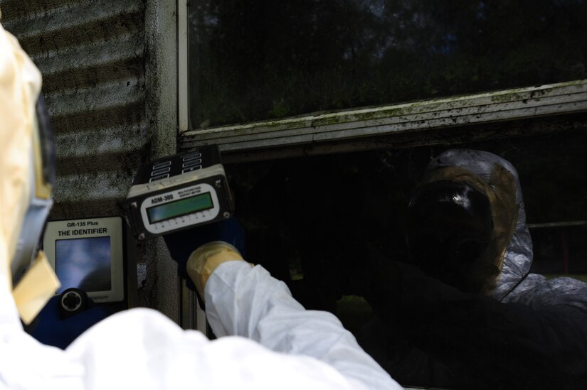 Senior Airman Nathan Pringle, 628th Civil Engineer Squadron emergency manager, checks for radiation during training exercise Operation Burnt Spear Aug. 24, 2012, at Joint Base Charleston, S.C. The emergency managers conducted radiological response training for a simulated incident involving a dirty bomb. In the scenario, a mock Federal Bureau of Investigation Joint Task Force requested Air Force Emergency Management assistance to verify and contain any radiation present from the device and establish a communication hotline for incoming responders. (U.S. Air Force photo/ Airman 1st Class Chacarra Walker)