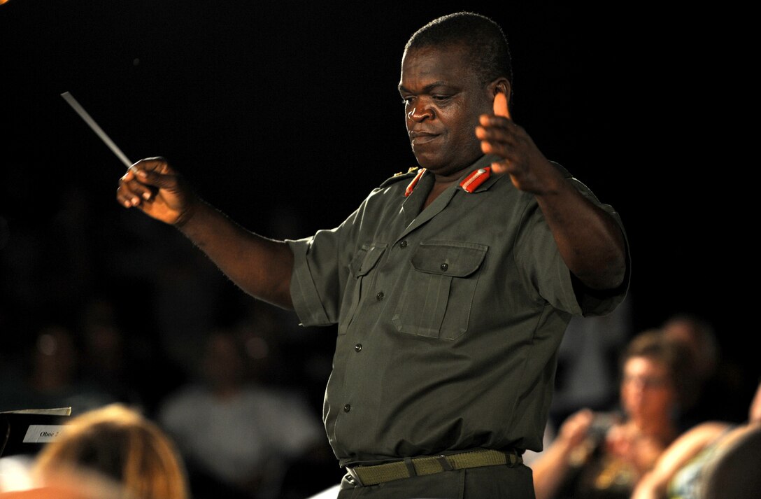 Col. Sampson Paa-Kwesi Ebonyi, director of music and bands of Ghana armed forces, conducts the U.S. Air Force band as they played for bystanders at the Air Force Memorial on August 24, 2012 in Washington D.C. The USAF Band hosts this concert every Tuesday from June 5-August 28. (U.S. Air Force photo by Senior Airman Christina Brownlow)