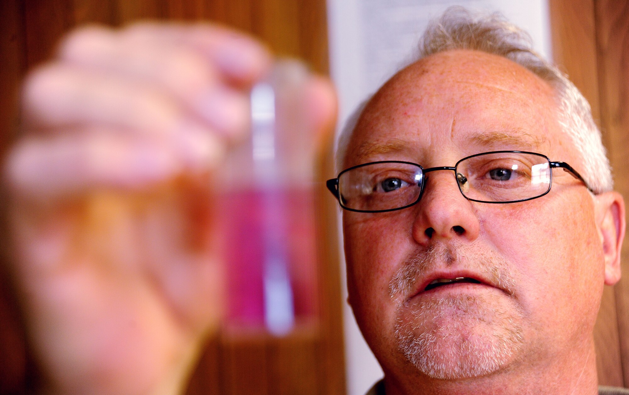 WHITEMAN AIR FORCE BASE, Mo. -- Paul Ross, 509th Civil Engineer Squadron central heat plant project manager, examines a mixture of chemicals during a water hardness test, Aug. 27. The test ensures no deposits of dissolved solids are in the water that could lead to a tube rupture. (U.S. Air Force photo/Senior Airman Nick Wilson) (Released)