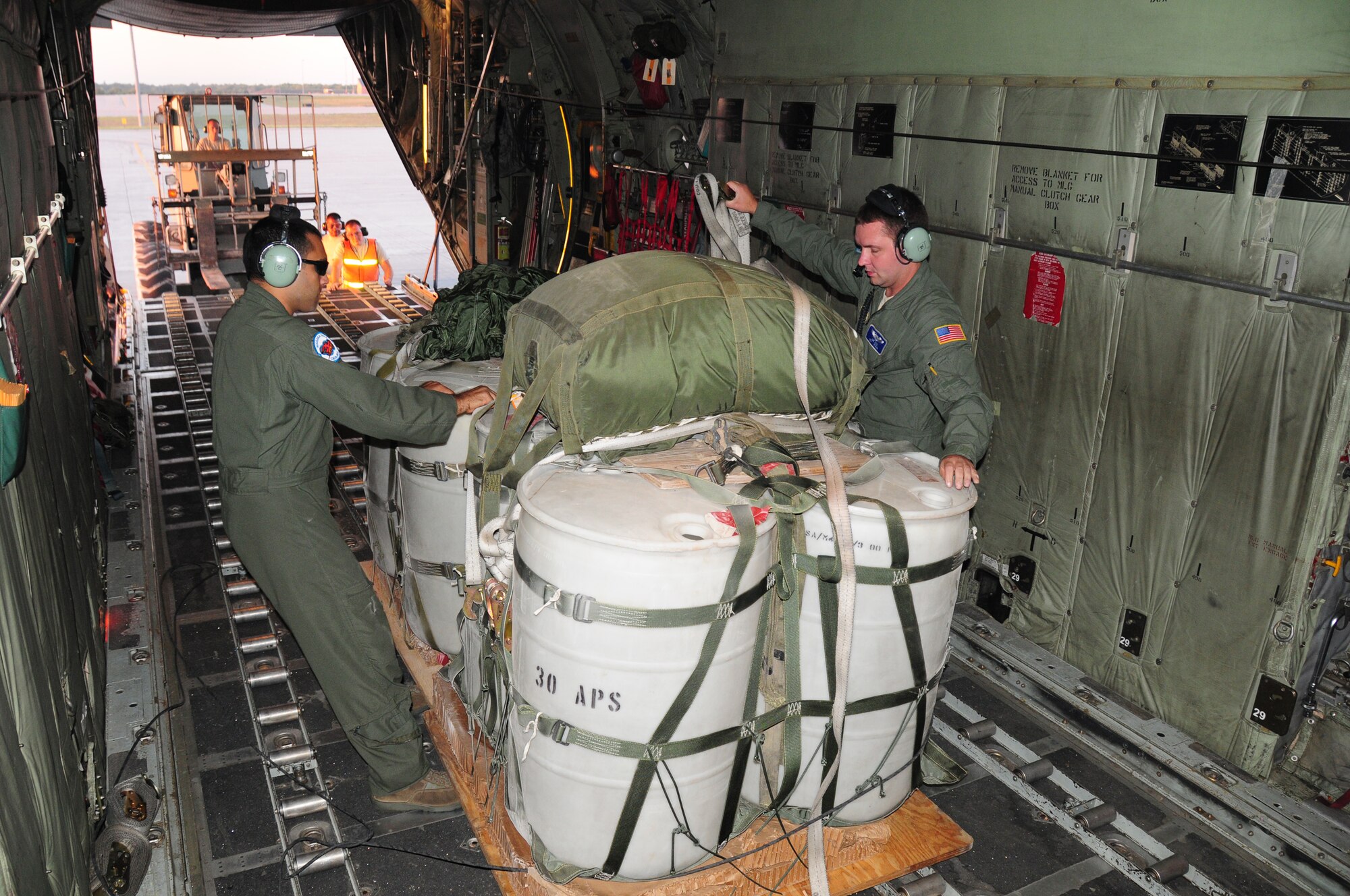 Tech Sgt. Philip Smith and Senior Airman Joe King, C-130 loadmasters from the 107th Airlift Wing secure the training cargo back on the C-130 aircraft from the earlier cargo drops at Fort Drum, NY. on Aug. 22, 2012  (U.S. Air Force Photo/Senior Master Sgt. Ray Lloyd)
