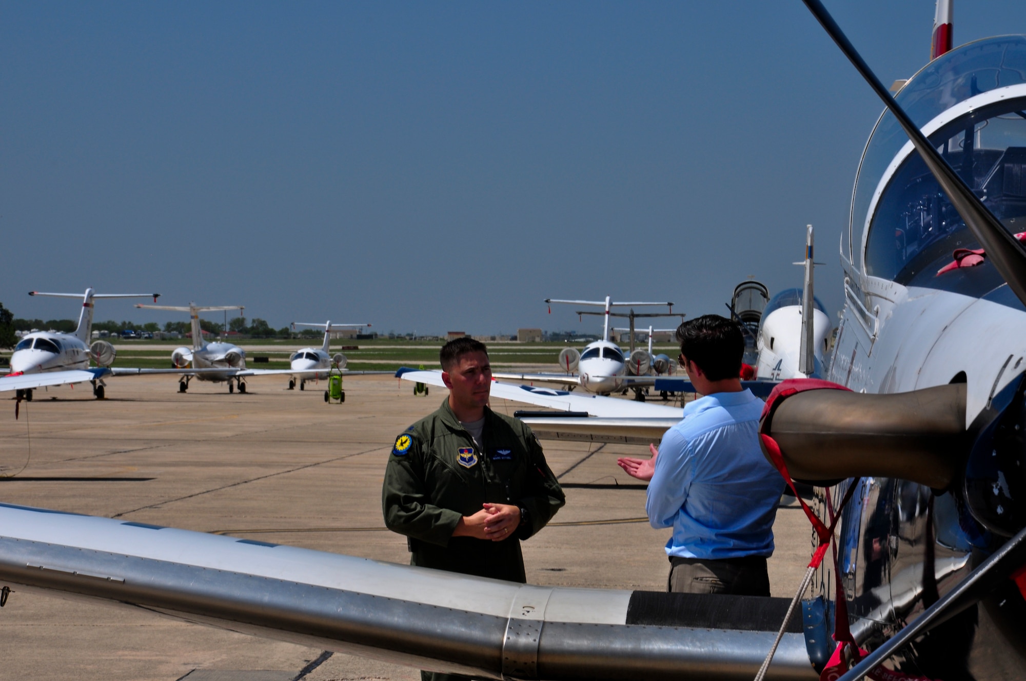 Lt. Col. Stitzel, 455th Flying Training Squadron director of operations, talks with Phil Anaya, KENS5 anchor and reporter, about the evacuation of aircraft from Naval Air Station Pensacola, Fla. to Joint Base San Antonio-Randolph,Texas, in preparation for Tropical Storm Isaac's landfall. (U.S. Air Force photo by 2nd Lt. Keenan Kunst)