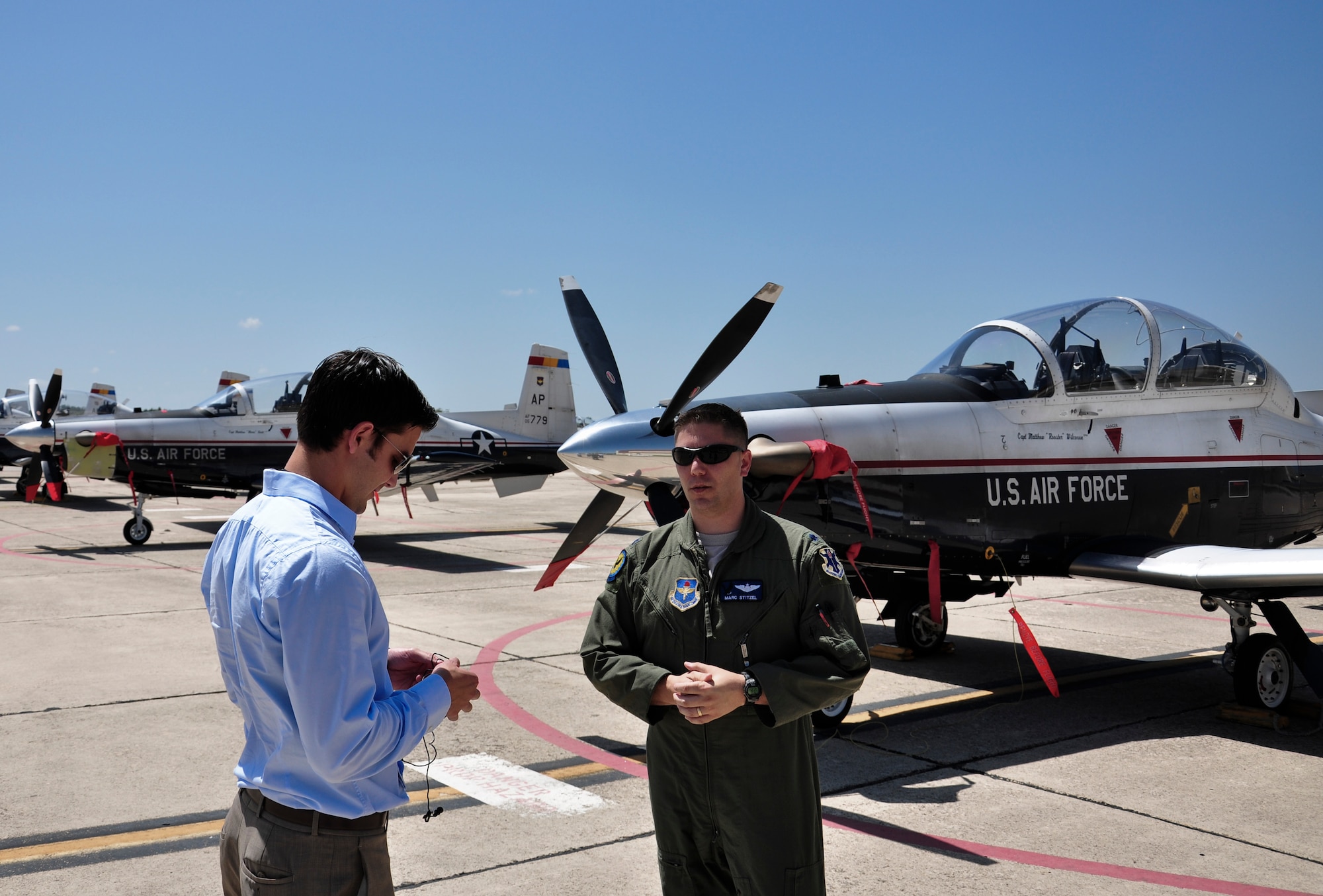 Lt. Col. Marc Stitzel, 455th Flying Training Squadron director of operations, talks with Phil Anaya, KENS5 anchor and reporter, about the evacuation of aircraft from Naval Air Station Pensacola, Fla., to Joint Base San Antonio-Randolph,Texas, in preparation for Tropical Storm Isaac's landfall. (U.S. Air Force photo by 2nd Lt. Keenan Kunst)