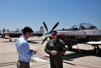 Lt. Col. Marc Stitzel, 455th Flying Training Squadron director of operations, talks with Phil Anaya, KENS5 anchor and reporter, about the evacuation of aircraft from Naval Air Station Pensacola, Fla., to Joint Base San Antonio-Randolph,Texas, in preparation for Tropical Storm Isaac's landfall. (U.S. Air Force photo by 2nd Lt. Keenan Kunst)