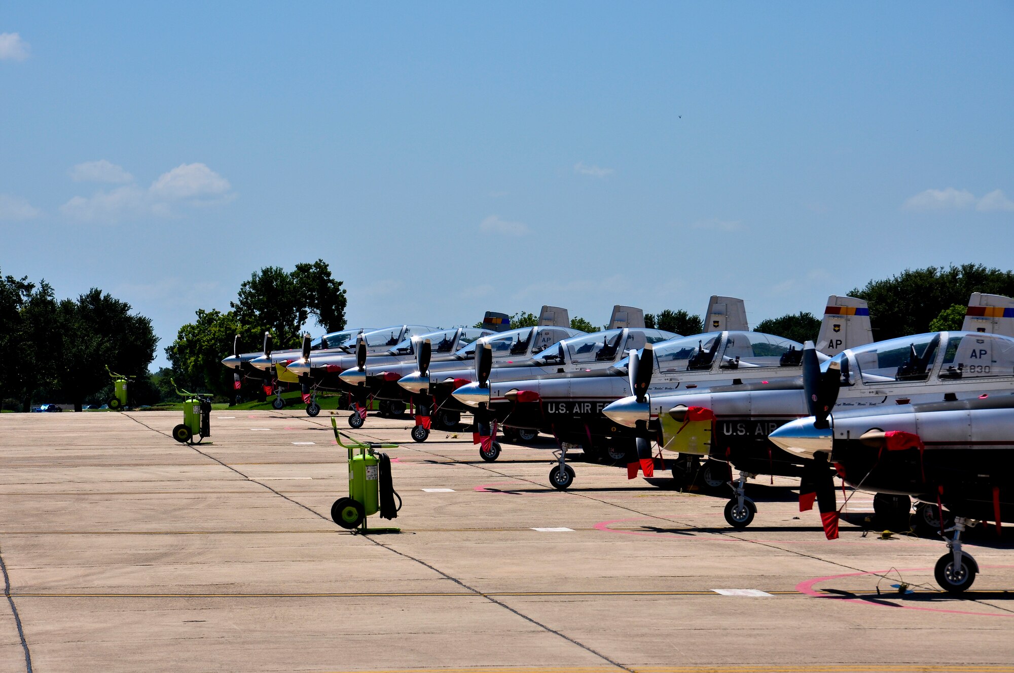 A line of T-6 Texan II aircraft sits on Joint Base San Antonio-Randolph's south ramp. These T-6s are used in the training of Combat Systems Officers by the 479th Flying Training Group, a geographically seperated unit of the 12th Flying Training Wing, at Naval Air Station Pensacola, Fla. The planes were flown to Randolph in anticipation of Tropical Storm Isaac.  (U.S. Air Force Photo by 2nd Lt. Keenan Kunst