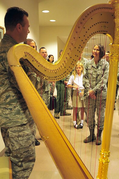 Air Force District of Washington Commander Maj. Gen. Sharon K.G. Dunbar, discusses music numbers with Senior Master Sgt. Eric Sabatino, U.S. Air Force Band harp soloist, during a tour of the band hangar Aug. 24 on Joint Base Anacostia-Bolling, Washington, D.C. (U.S. Air Force photo by Senior Airman Steele C. G. Britton)