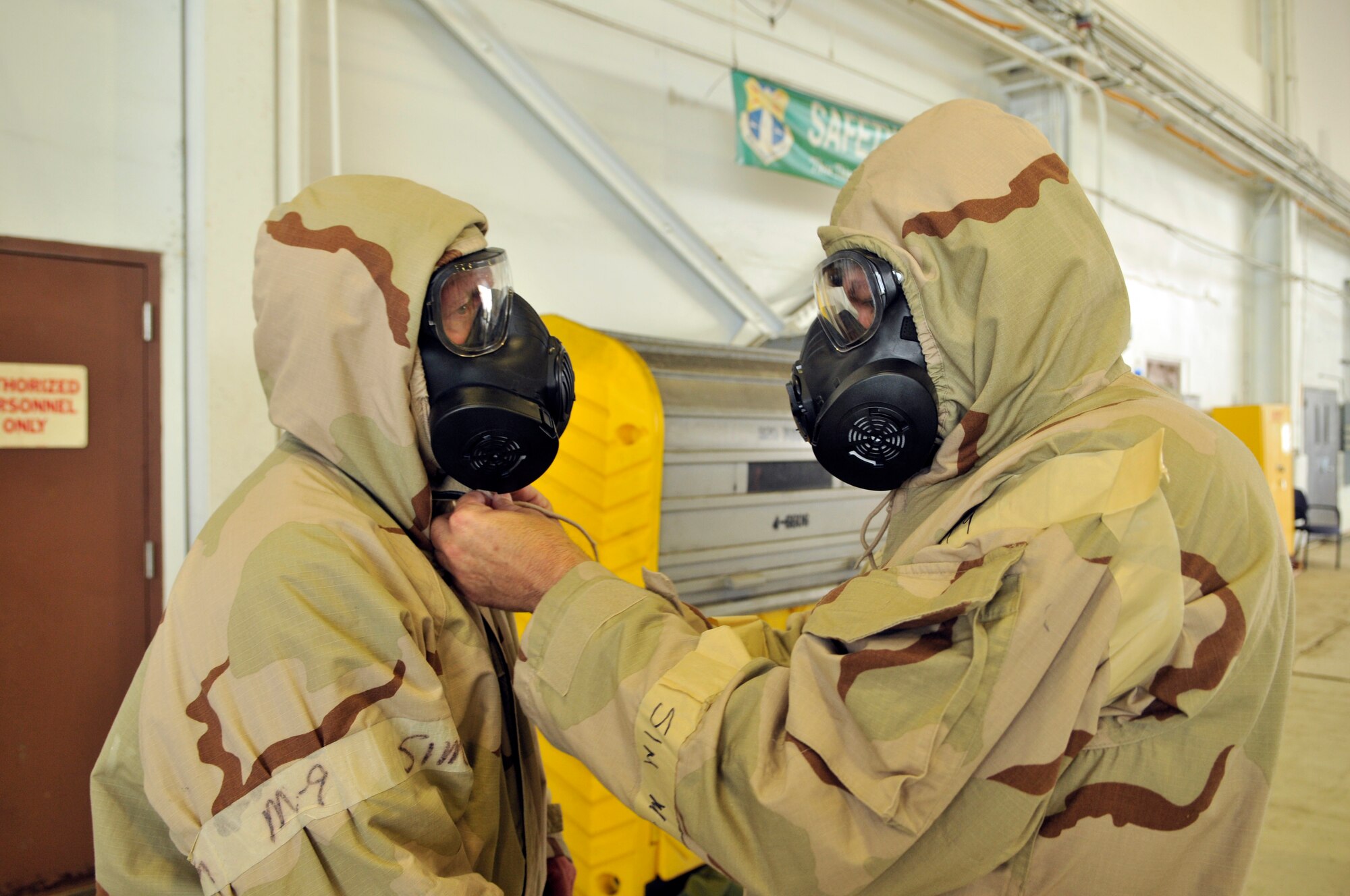 PATRICK AIR FORCE BASE, Fla., Chief Master Sgt. Phil Roe, on right and Senior Master Sgt. Scott Pittman worked as a team to correctly don their Mission Oriented Protective Posture (MOPP) gear. The two are part of the Exercise Evaluation Team (EET) for the 920th Rescue Wing’s upcoming Operational Readiness Exercise. To familiarize themselves with the skills that they will be evaluating, they participated in an Ability To Survive and Operate (ATSO) training exercise held here during a recent UTA. (U.S. Air Force photo/Tech. Sgt. Peter Dean)