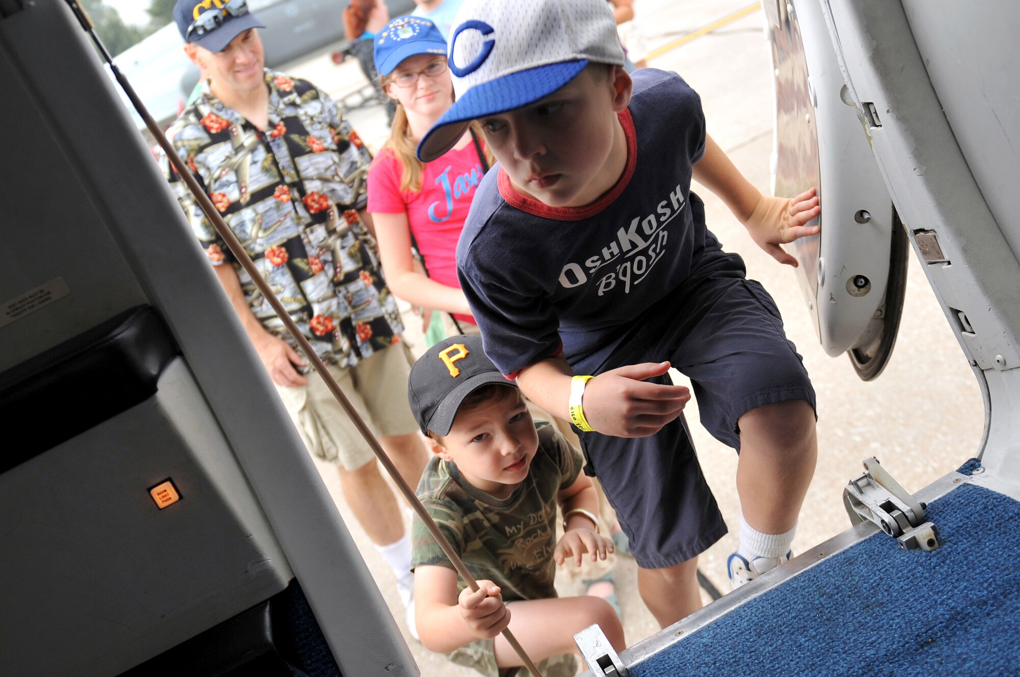 Children take their first steps on an aircraft displayed at the 2012 Defenders of Freedom Open House and Air Show on Offutt Air Force Base, Neb., Aug. 26. The air show had more than 30 static displays including a B-1 Bomber and an AV-8B Harrier. (U.S. Air Force photo by Jeff W. Gates/Released)