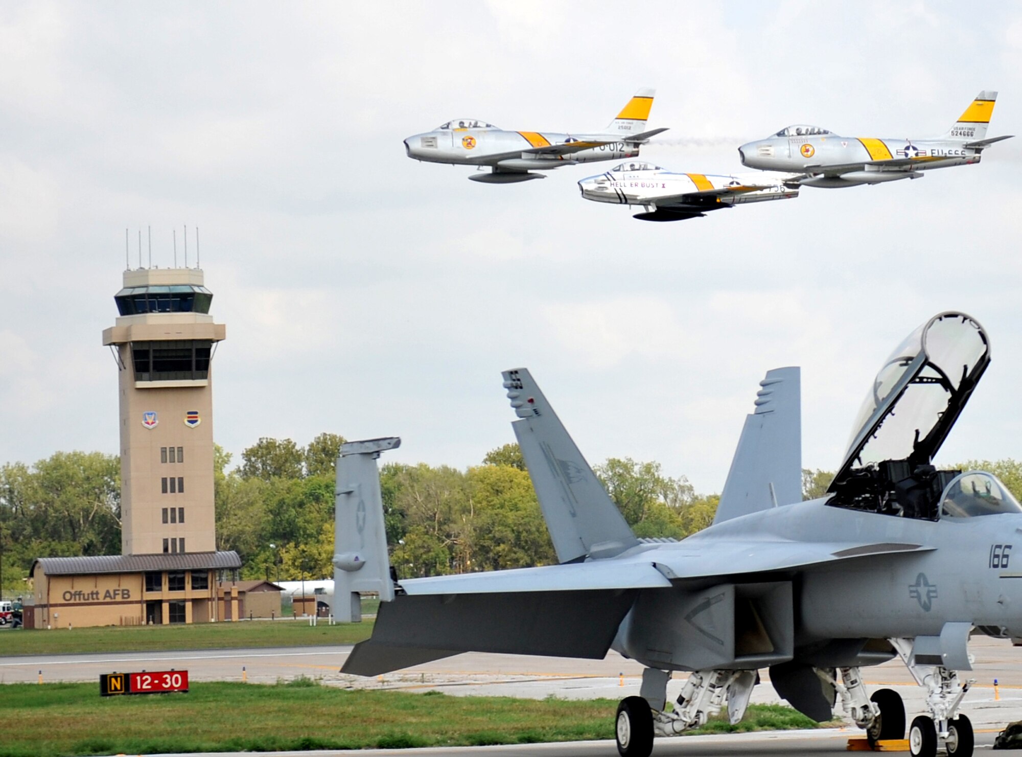 The F-86 Sabre demo team flies by the flight tower during the 2012 Defenders of Freedom Open House and Air Show on Offutt Air Force Base, Neb., Aug. 26. The F-86 Sabre’s were flown by The Horsemen Flight Team. (U.S. Air Force photo by Jeff W. Gates/Released)