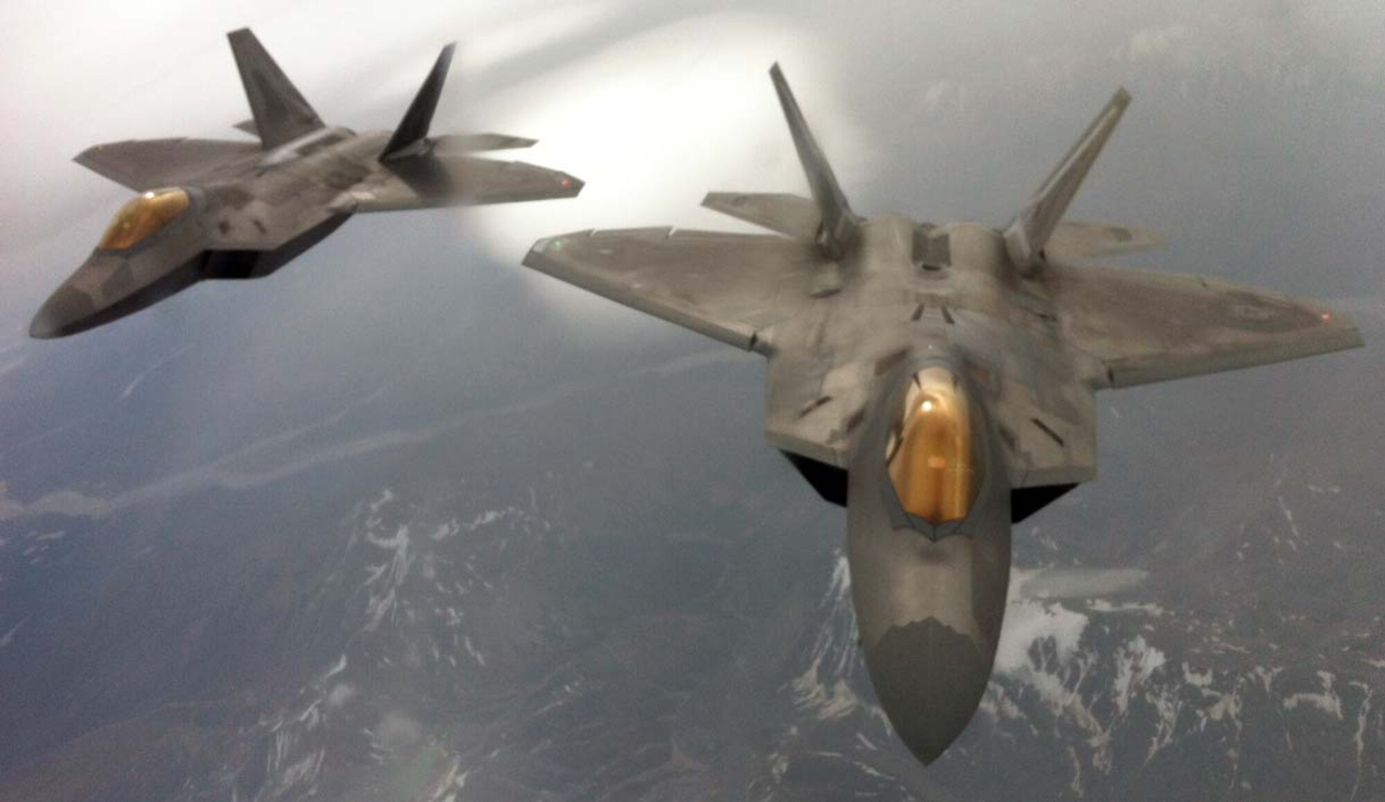 A pair of F-22 Raptors assigned to Elmendorf Air Force Base, Alaska, trail behind a KC-135 Stratotanker from McConnell Air Force Base, Kan., during an air refueling mission Aug. 24, 2012. The Stratotanker was manned by an aircrew made up of Reservists from the 931st Air Refueling Group. (U.S. Air Force photo by Senior Master Sgt. Ray Lewis)
