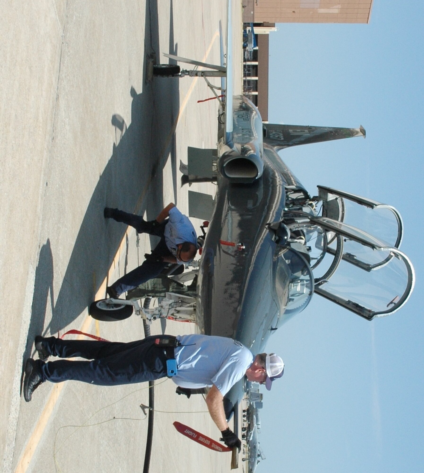 Transient Alert Mechanic Glenn Larson, 72nd Operations Support Squadron, examines a T-38’s pitot tube, which measures airspeed, while Aircraft Servicer John Pszczola inspects the landing gear on the trainer. The aircraft arrived at Tinker on Aug. 15 from Sheppard AFB, Texas. (Air Force photo by Mike Ray)