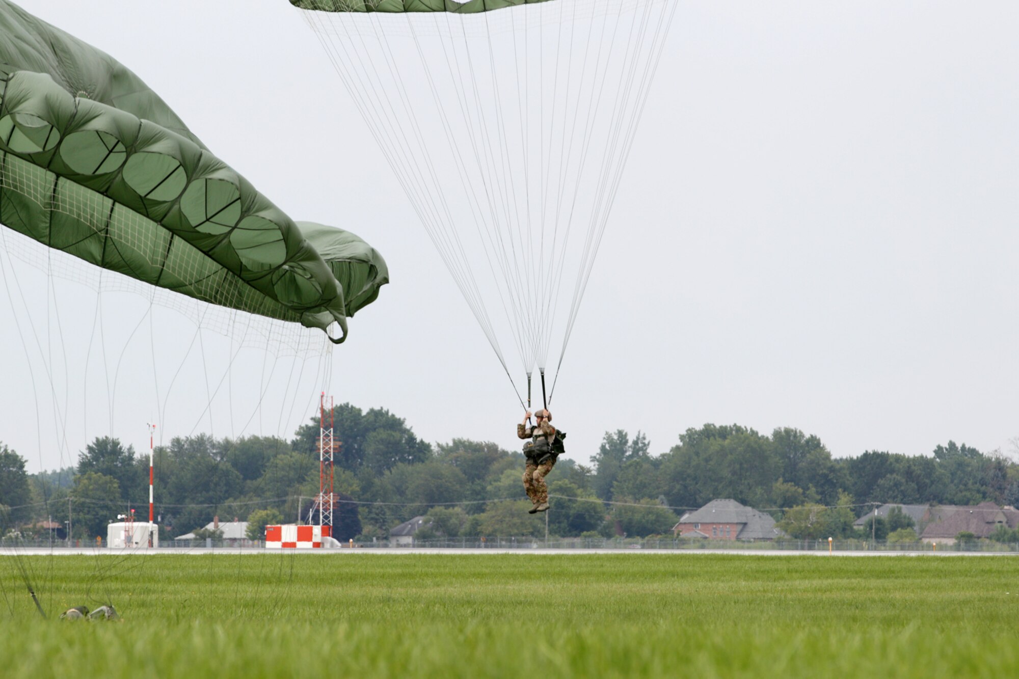 TSgt. Richard Fisher, 107th Weather Flight, Michigan Air National Guard, prepares to land after a successful parachute jump at Selfridge Air National Guard Base, Mich., Aug. 13, 2012. The Weather Flight is a special operations team with members proficient in a wide variety of military skills – in addition to being trained as weather forecasting specialists. Knowledge of weather conditions can be a crucial piece of data for military commanders during any type of operation. (Air National Guard photo by SrA. Toni Stusse)