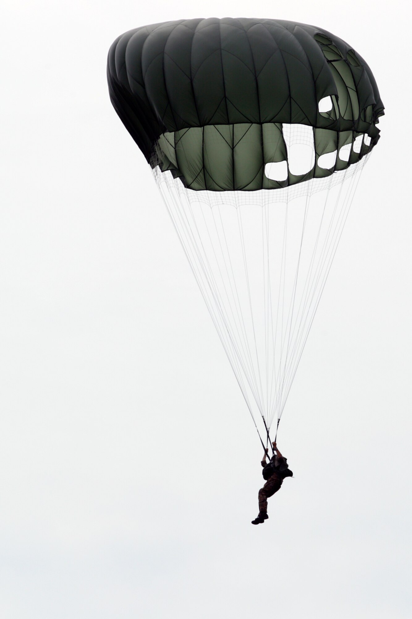 2Lt. Robert McLean, commander of the 107th Weather Flight, Michigan Air National Guard, prepares to land after a successful parachute jump at Selfridge Air National Guard Base, Mich., Aug. 13, 2013. The Weather Flight is a special operations team with members proficient in a wide variety of military skills – in addition to being trained as weather forecasting specialists. Knowledge of weather conditions can be a crucial piece of data for military commanders during any type of operation. (Air National Guard photo by SrA. Toni Stusse)