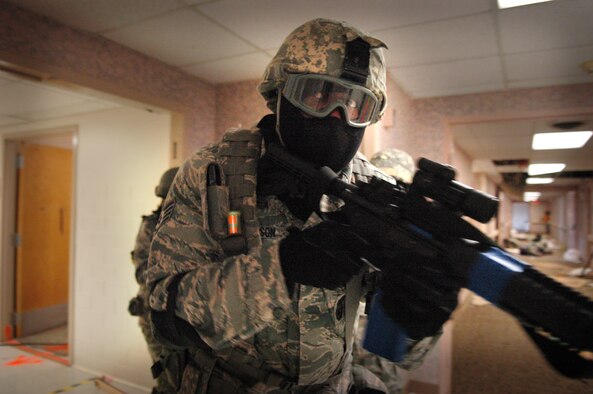 Staff Sgt. Kendrick Monson rounds a corner as his team searches the abandoned clinic for an active shooter during an exercise in the old 72nd Medical Group clinic. (Air Force photo by Micah Garbarino)