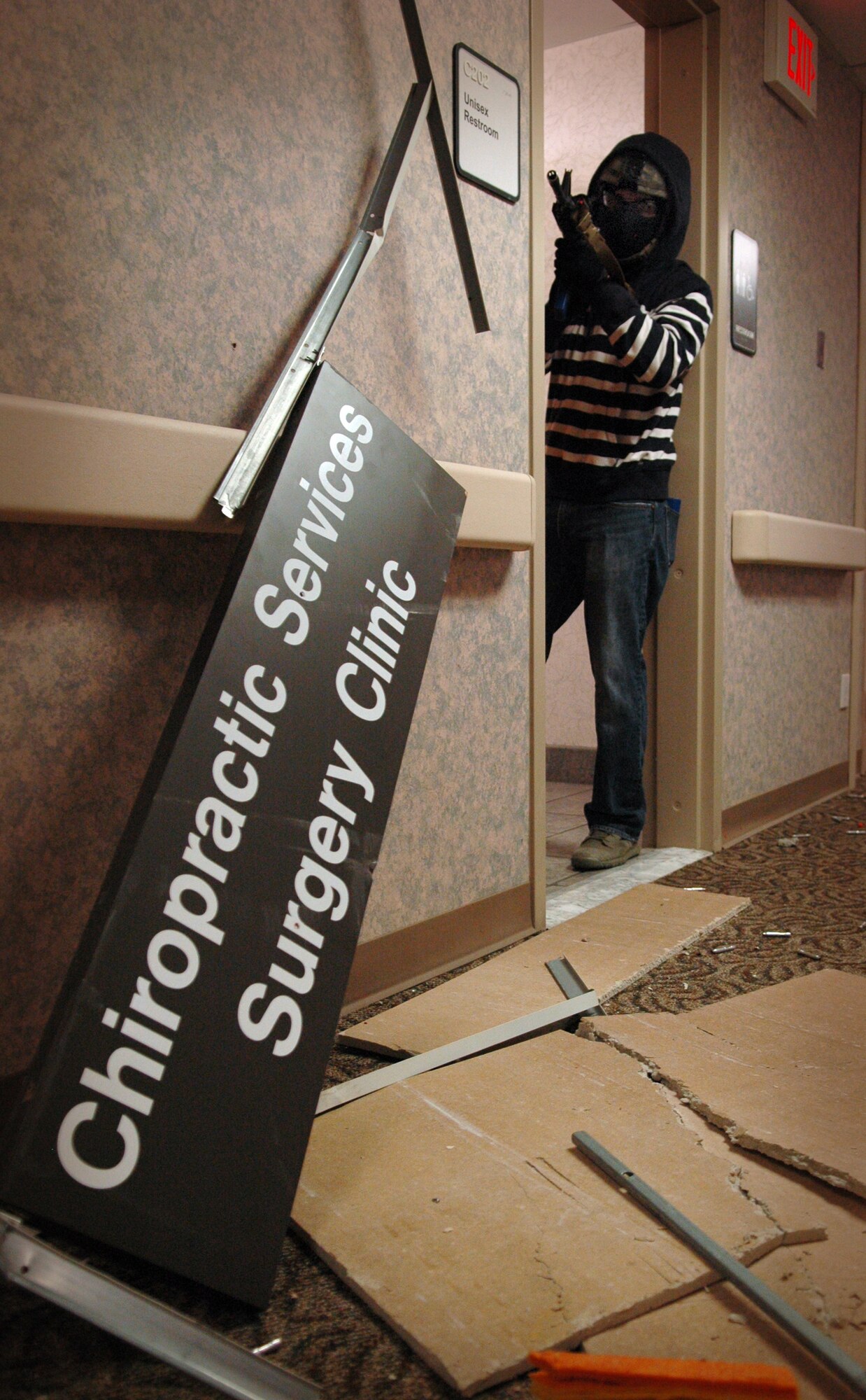 Staff Sgt. Conrado Montes, playing an active shooter on a rampage, returns fire with “sim” rounds as a team of 72nd Security Forces members try to take him out during a training exercise in Tinker’s soon-to-be-demolished clinic. More than 100 officers rotated through the training, which lasted five days. (Air Force photo by Micah Garbarino)