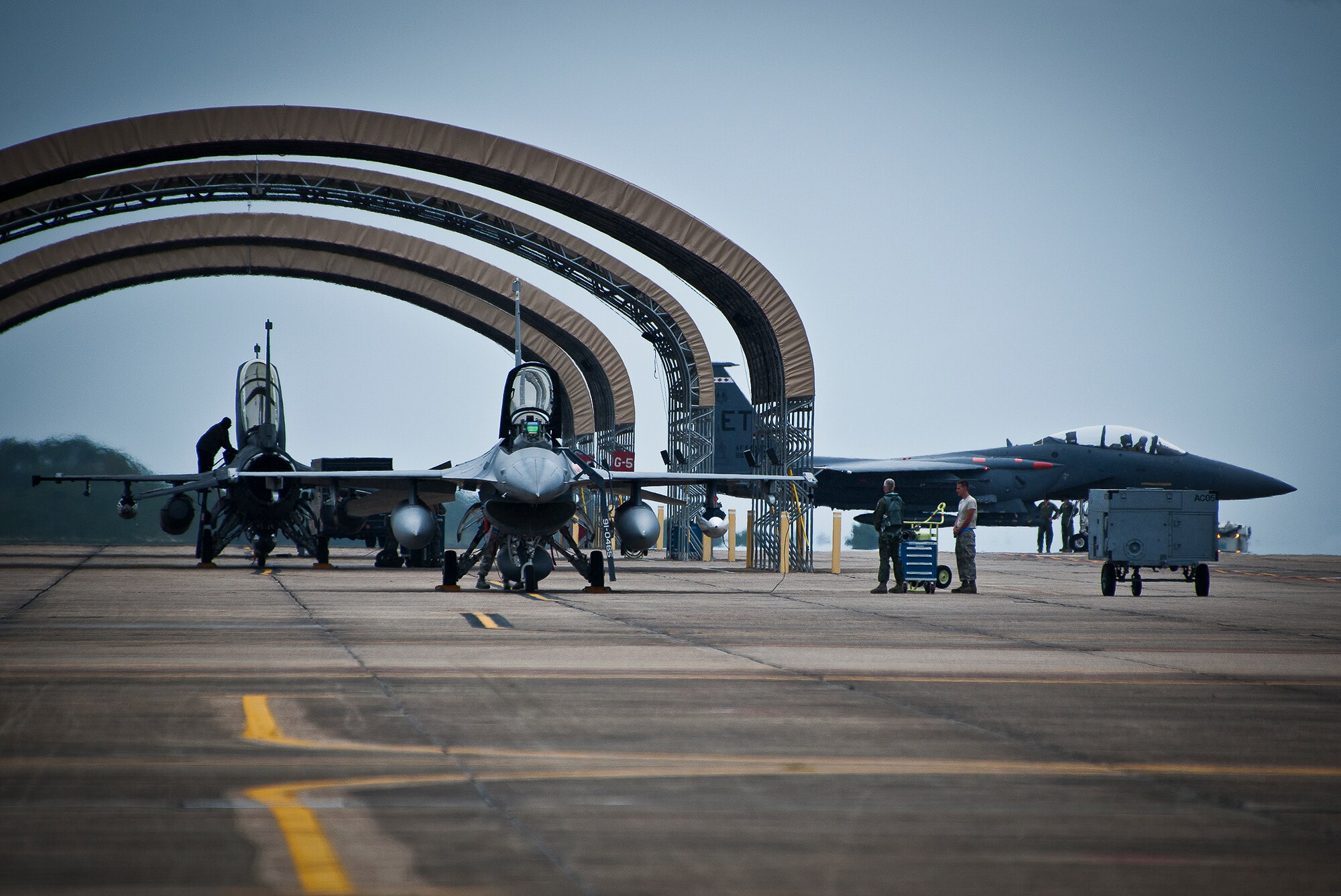 A 96th Test Wing F-15 taxis past two F-16s toward the runway at Eglin Air Force Base, Fla., Aug. 27.  The 96th and the 53rd Wing evacuated their aircraft due to the impending arrival of Hurricane Isaac.  The Wings’ F-16s flew to Shaw Air Force Base, S.C., and the F-15s flew to Seymour Johnson Air Force Base, N.C.  (U.S. Air Force photo/Samuel King Jr.)  