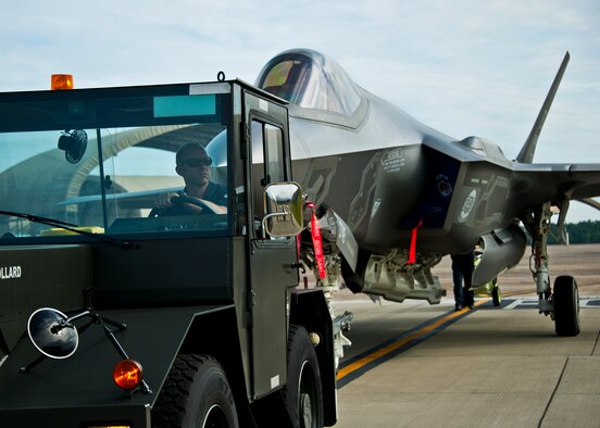 An Airman from the 33rd Maintenance Squadron pulls an Air Force F-35A Lightning II off the flightline and into a hangar at Eglin Air Force Base, Fla., Aug. 27.  The 33rd Fighter Wing’s joint strike fighters were moved into hangars in preparation for the arrival of Hurricane Isaac.  The 58th Fighter Squadron hangar held nine A models, while the Marine Fighter Attack Squadron 501 hangar stored the 10 B models.  (U.S. Air Force photo/Samuel King Jr.)  