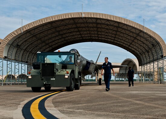 Members of the 33rd Maintenance Squadron move an Air Force F-35A Lightning II off the flightline and into a hangar at Eglin Air Force Base, Fla., Aug. 27.  The 33rd Fighter Wing’s joint strike fighters were moved into hangars in preparation for the arrival of Hurricane Isaac.  The 58th Fighter Squadron hangar held nine A models, while the Marine Fighter Attack Squadron 501 hangar stored the 10 B models.  (U.S. Air Force photo/Samuel King Jr.)  