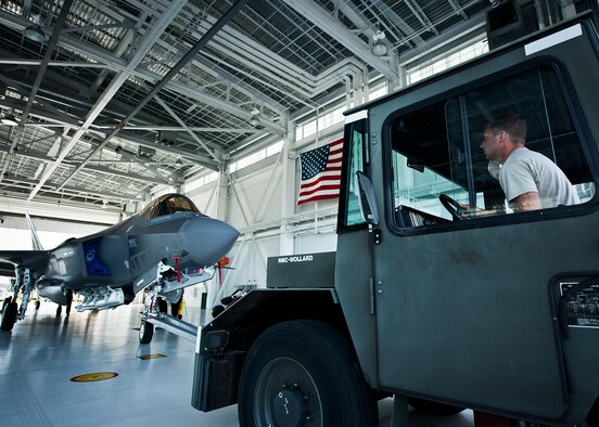 A 33rd Maintenance Squadron Airman backs in an Air Force F-35A Lightning II into the 58th Fighter Squadron hangar at Eglin Air Force Base, Fla., Aug. 27.  The 33rd Fighter Wing’s joint strike fighters were moved into hangars in preparation for the arrival of Hurricane Isaac.  The 58th hangar held nine A models, while the Marine Fighter Attack Squadron 501 hangar stored the 10 B models.  (U.S. Air Force photo/Samuel King Jr.)  